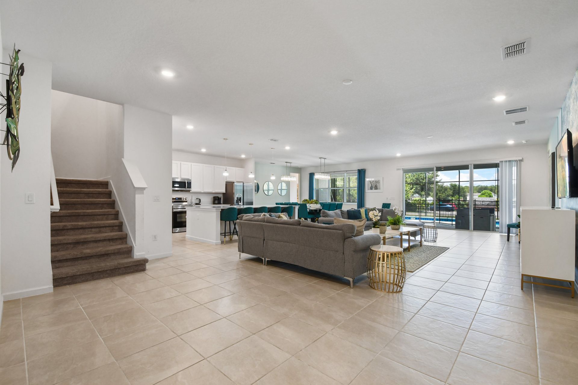 Open-concept living space with modern décor, natural light, and a private pool view!