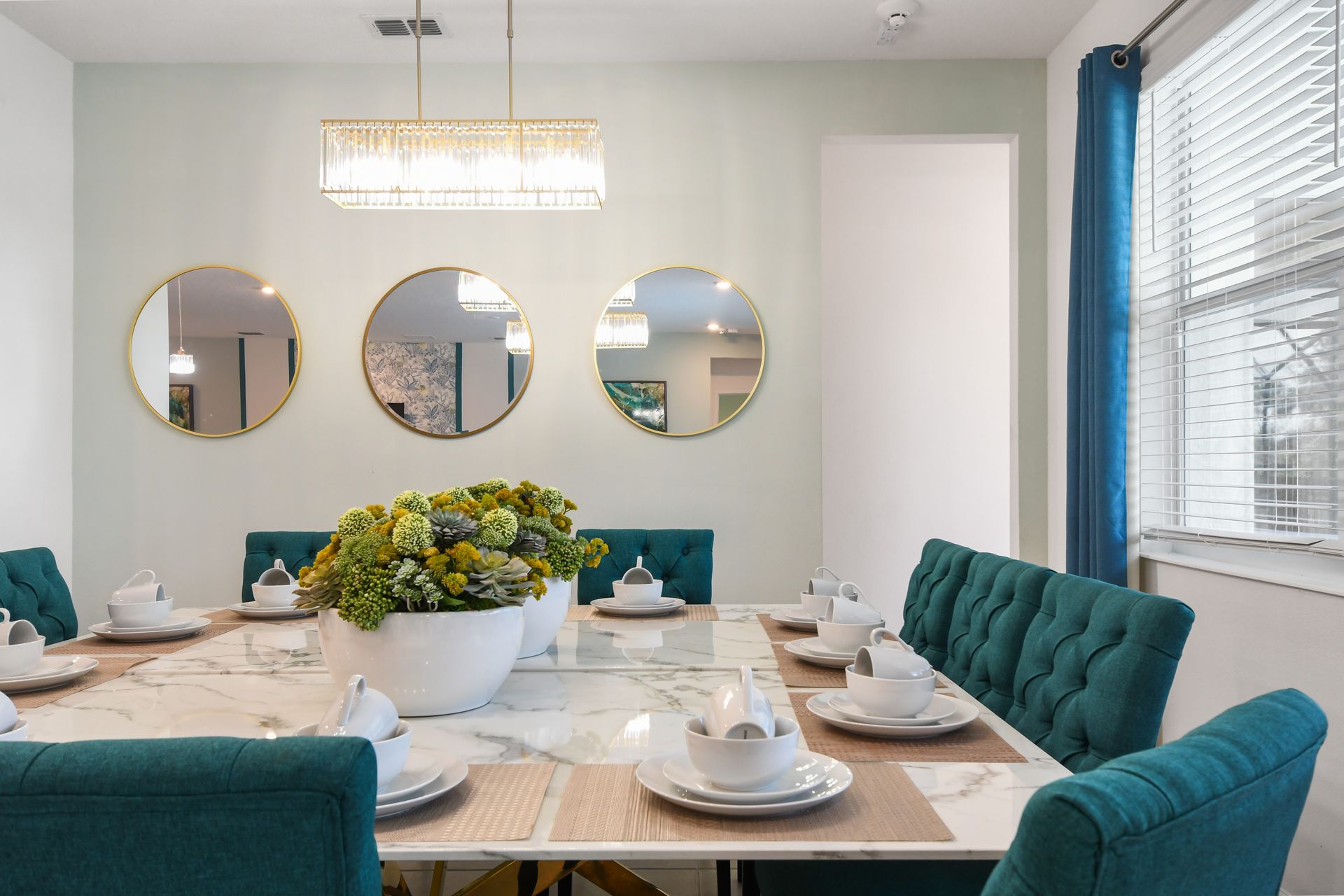 Sophisticated dining space with a marble table, plush seating, and elegant lighting!