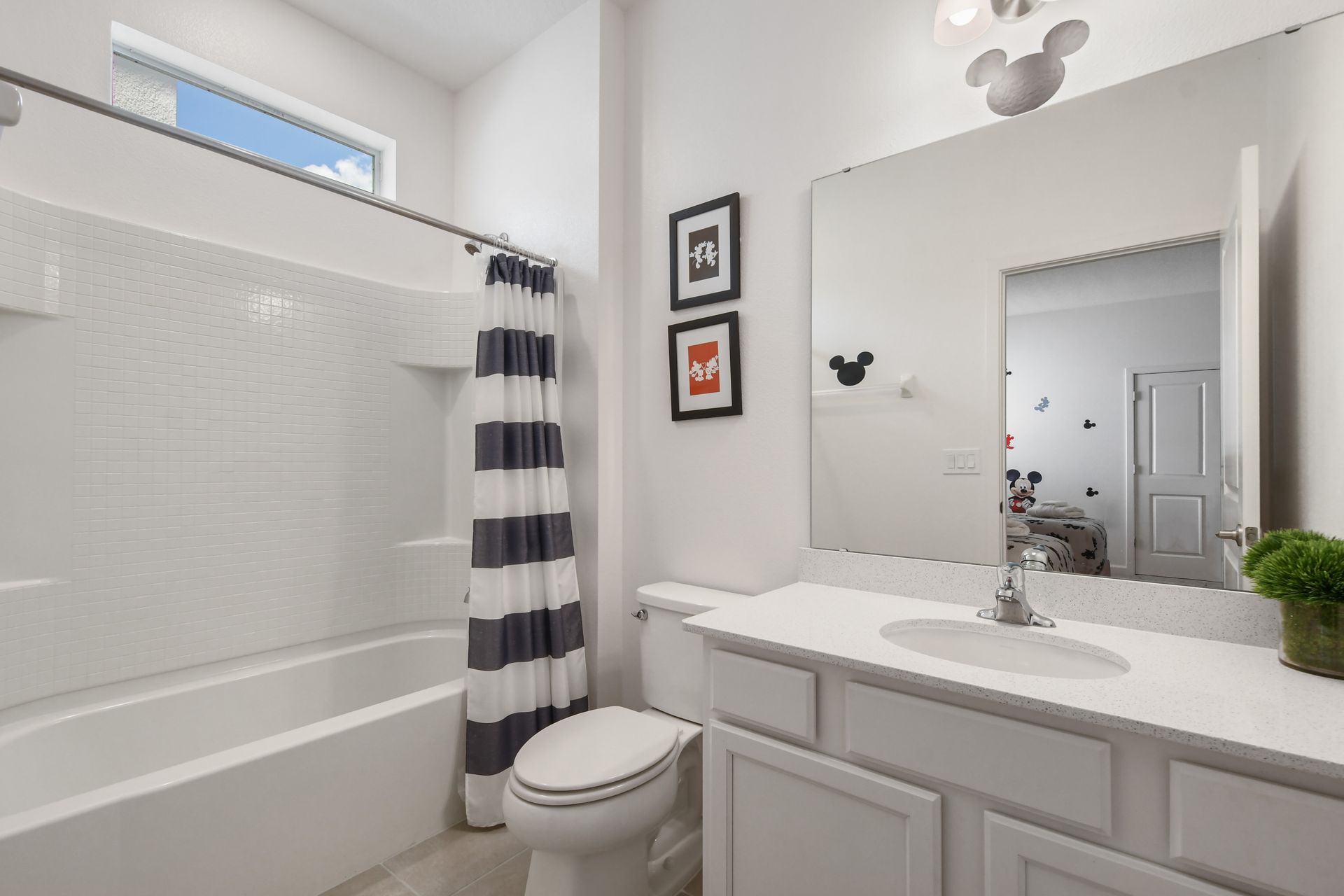 Bright coastal-themed bathroom with a tub, perfect for a relaxing getaway!