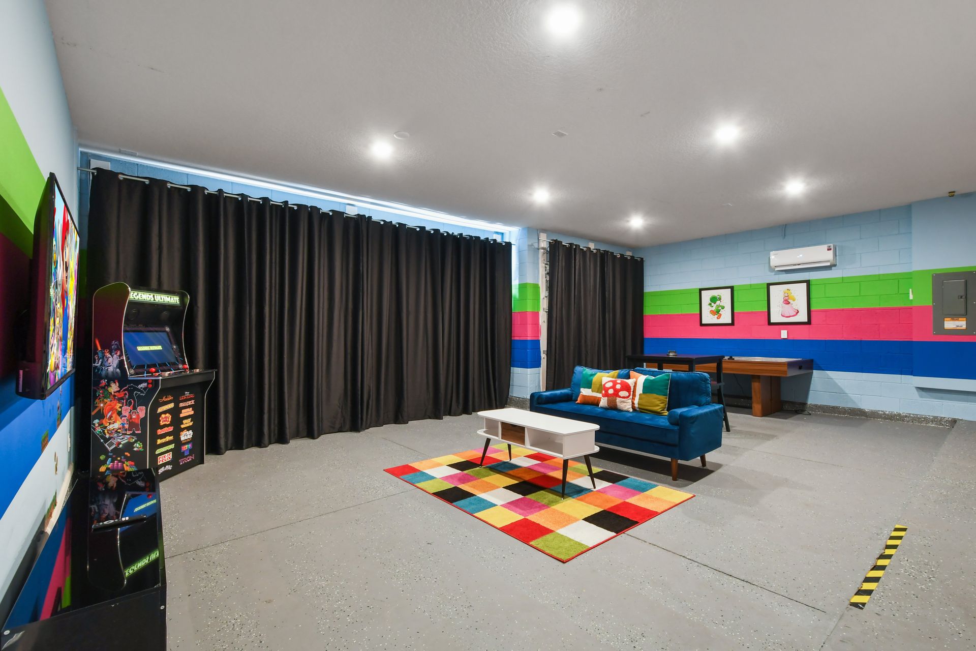 Fun-filled game room with arcade games, vibrant décor, and cozy lounge seating!