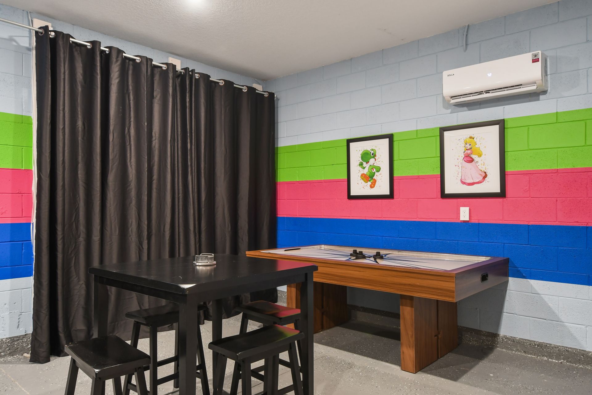 Colorful game room with air hockey, fun décor, and a cozy hangout space!