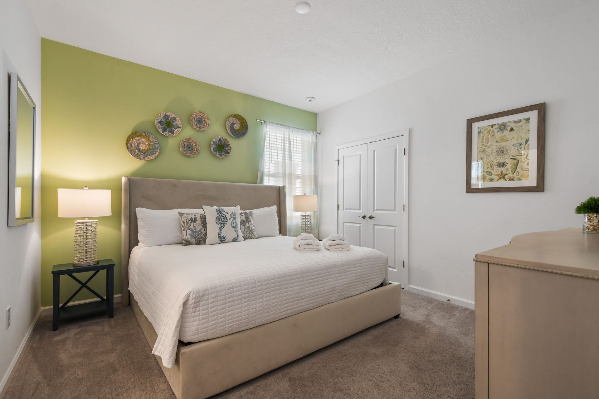 Tranquil bedroom with a coastal touch, plush bedding, and soothing green accents!