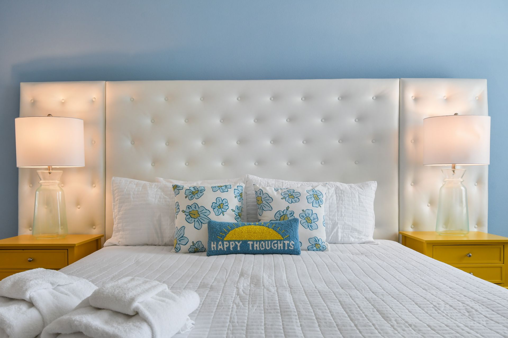 Bright and cheerful bedroom with a plush bed, sunny accents, and a relaxing vibe!