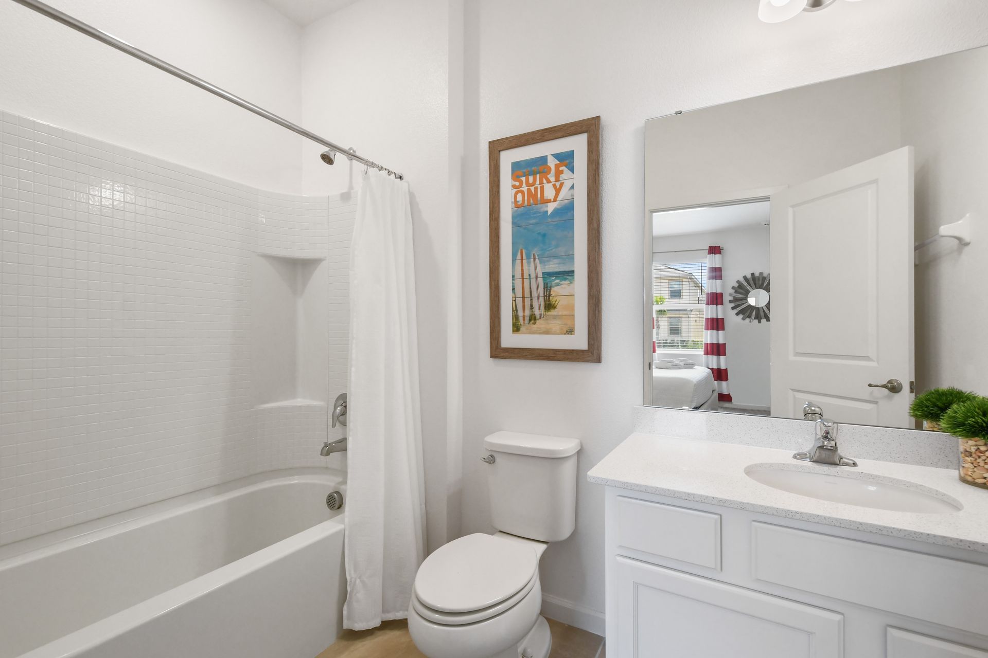 Bright coastal-themed bathroom with a tub, perfect for a relaxing getaway!