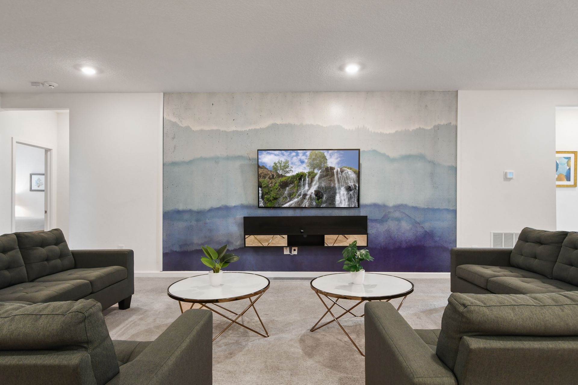 Stylish lounge with modern décor, cozy seating, and a stunning accent wall!