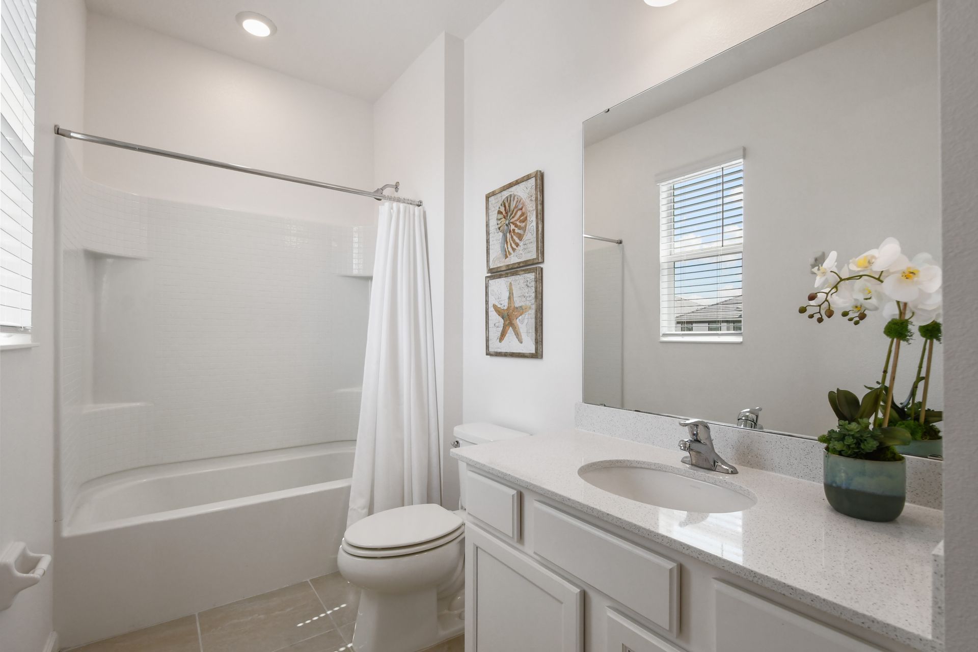 Bright coastal-themed bathroom with a tub, perfect for a relaxing getaway!