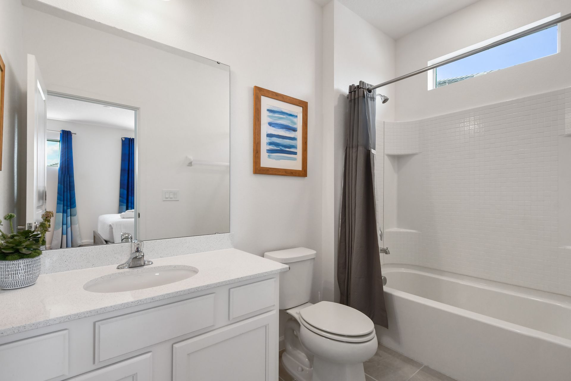 Bright coastal-themed bathroom with a tub, perfect for a relaxing getaway!