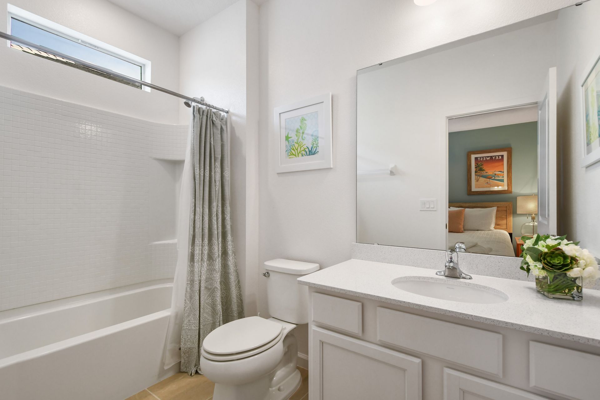 Bright coastal-themed bathroom with a tub, perfect for a relaxing getaway!