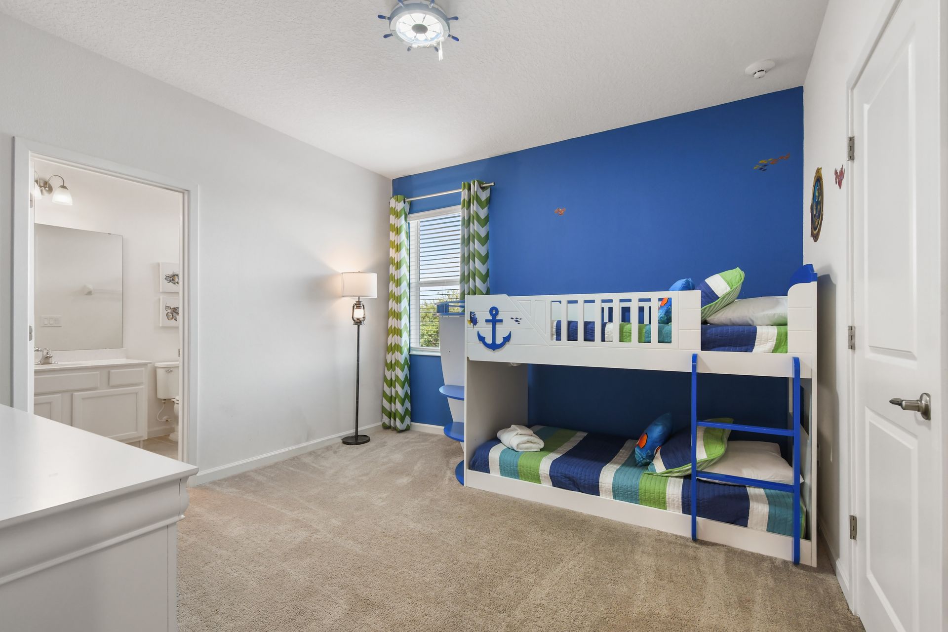Bright nautical-themed room with a fun boat bunk bed—perfect for little sailors!