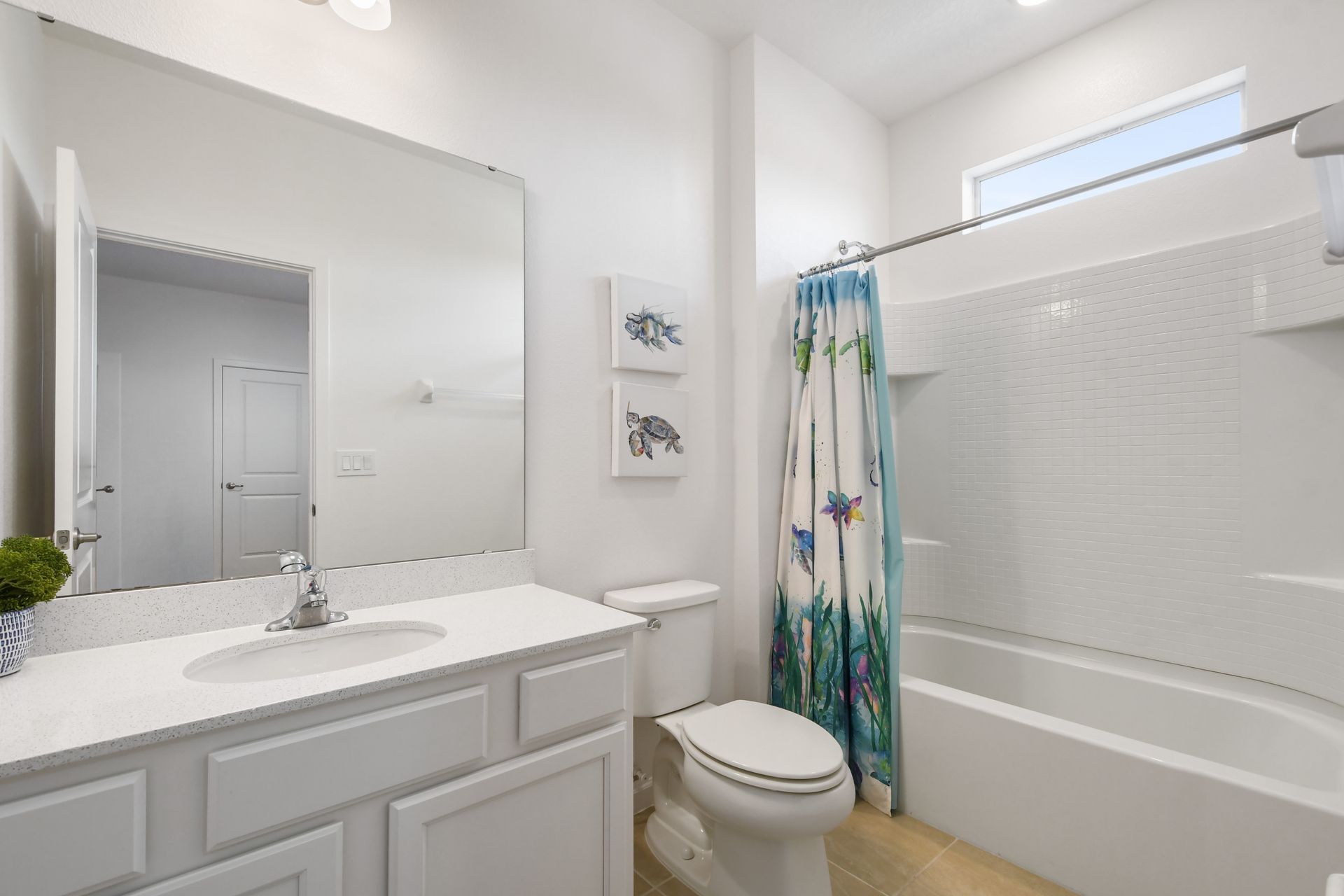 Bright coastal-themed bathroom with a tub, perfect for a relaxing getaway!