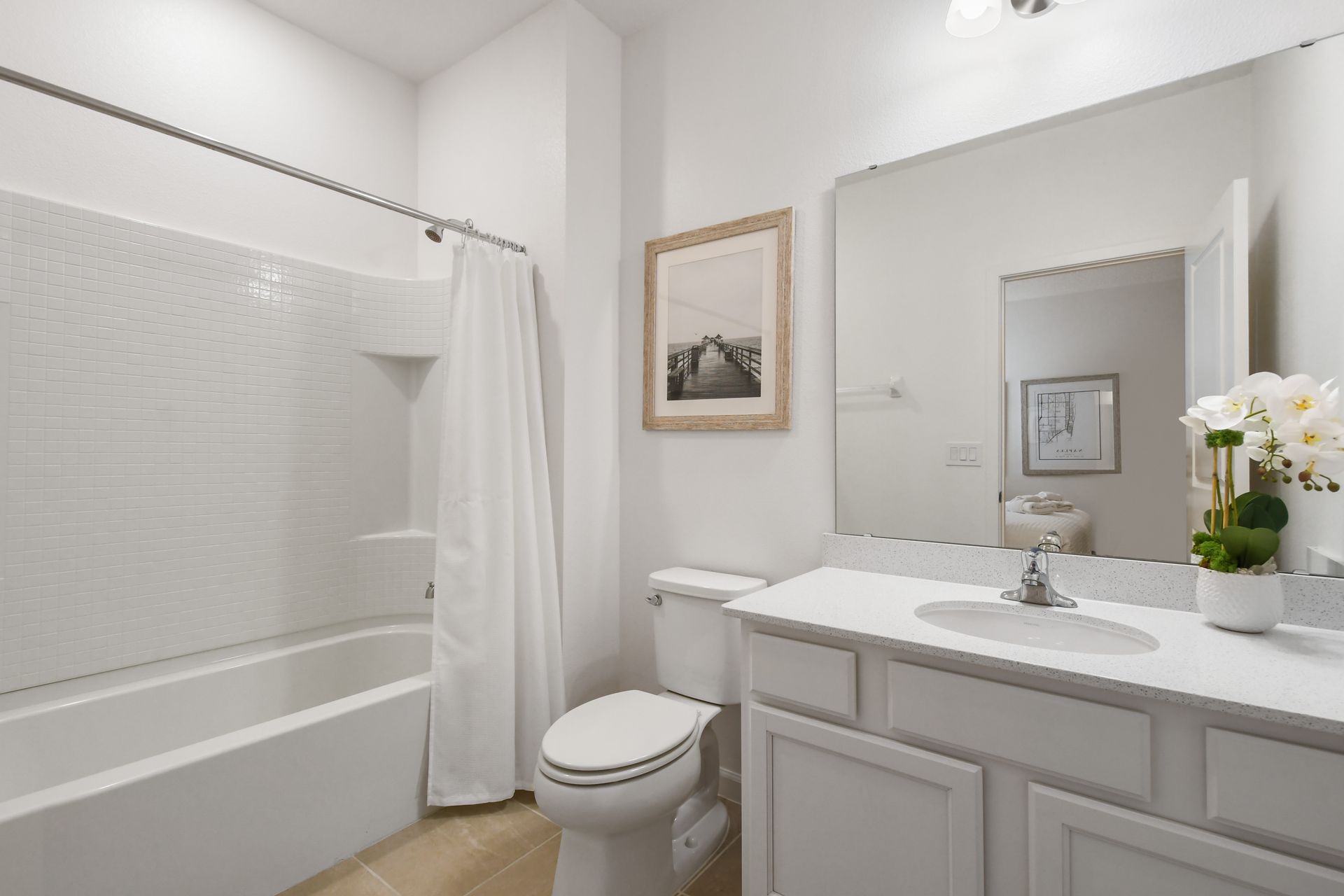 Bright coastal-themed bathroom with a tub, perfect for a relaxing getaway!