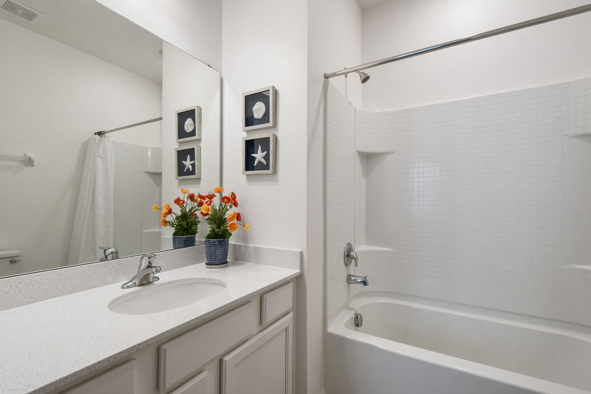Bright coastal-themed bathroom with a tub, perfect for a relaxing getaway!