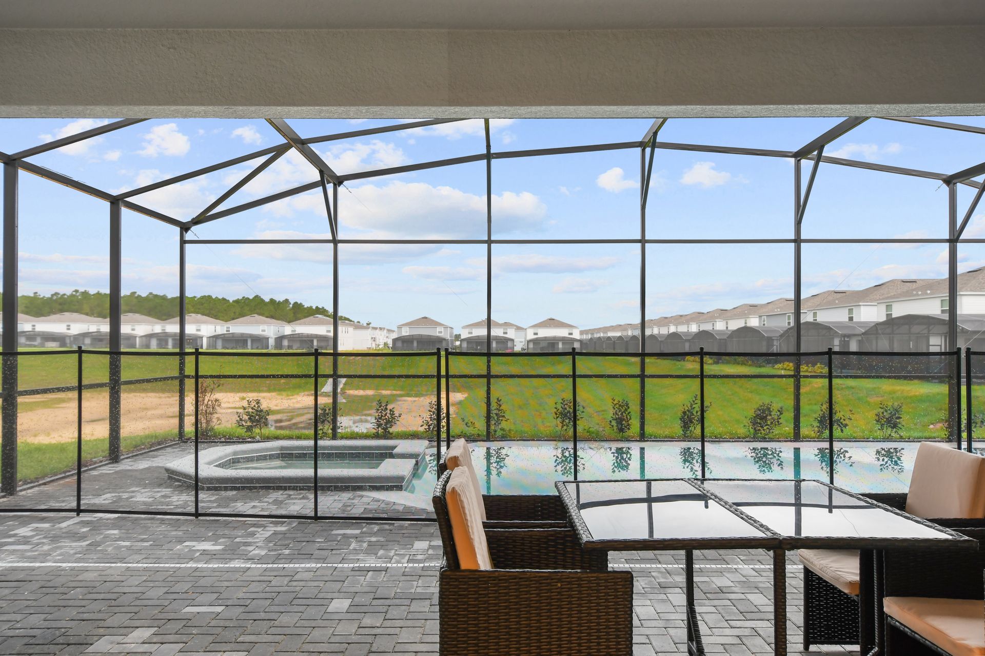 Relax with serene views in this screened patio, complete with pool and spa.