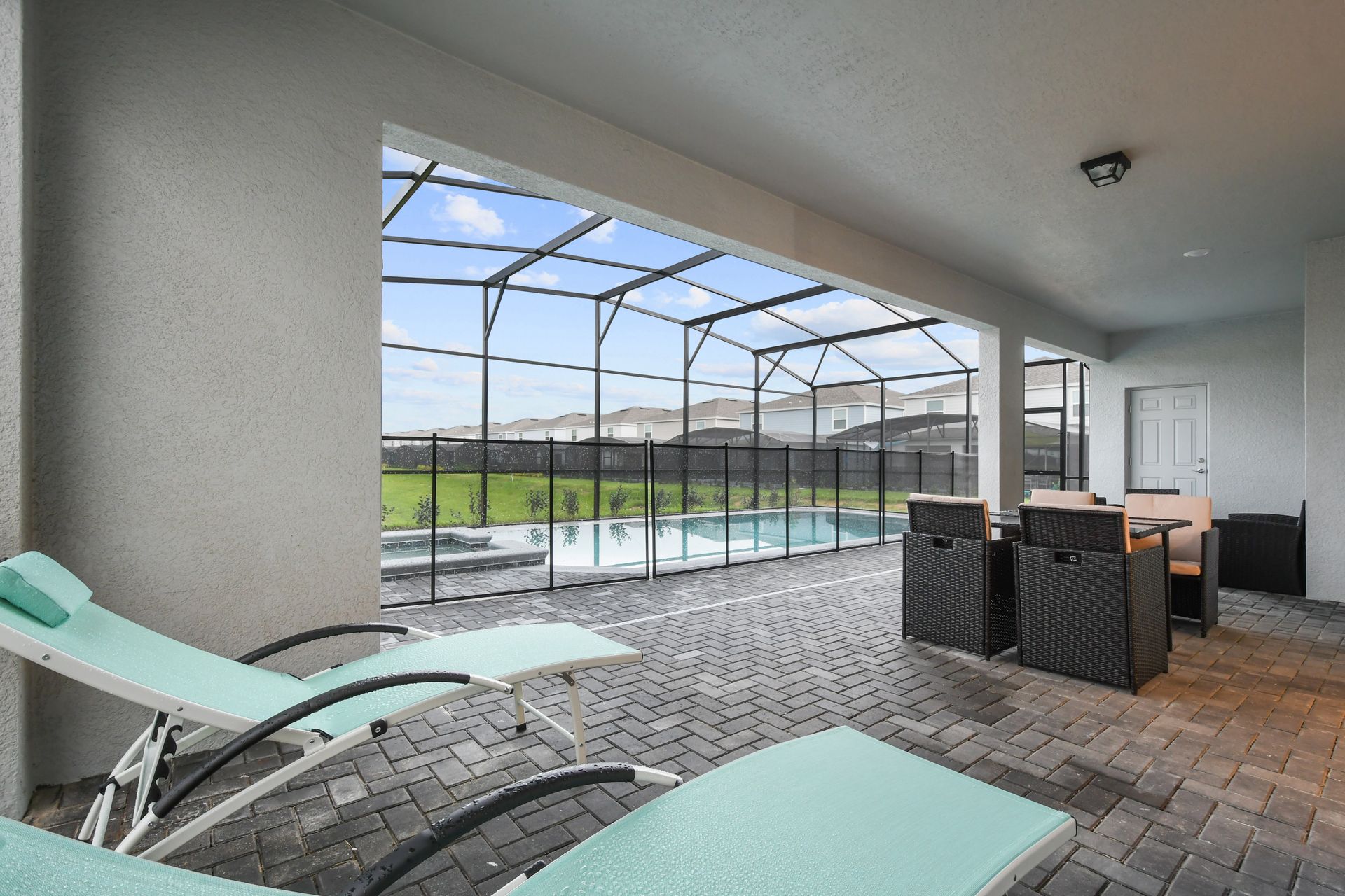 Relax in the shaded lanai with pool views and comfy lounge seating.