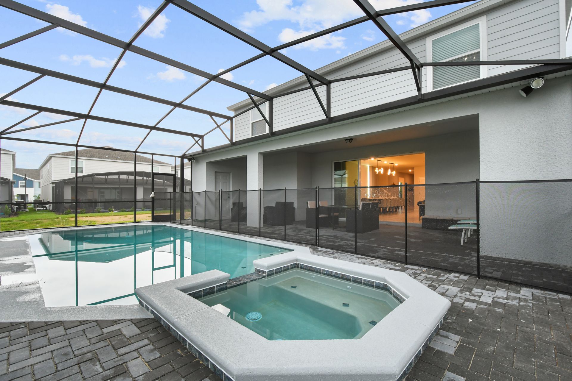 Relax in the private screened-in pool and spa with covered patio seating.