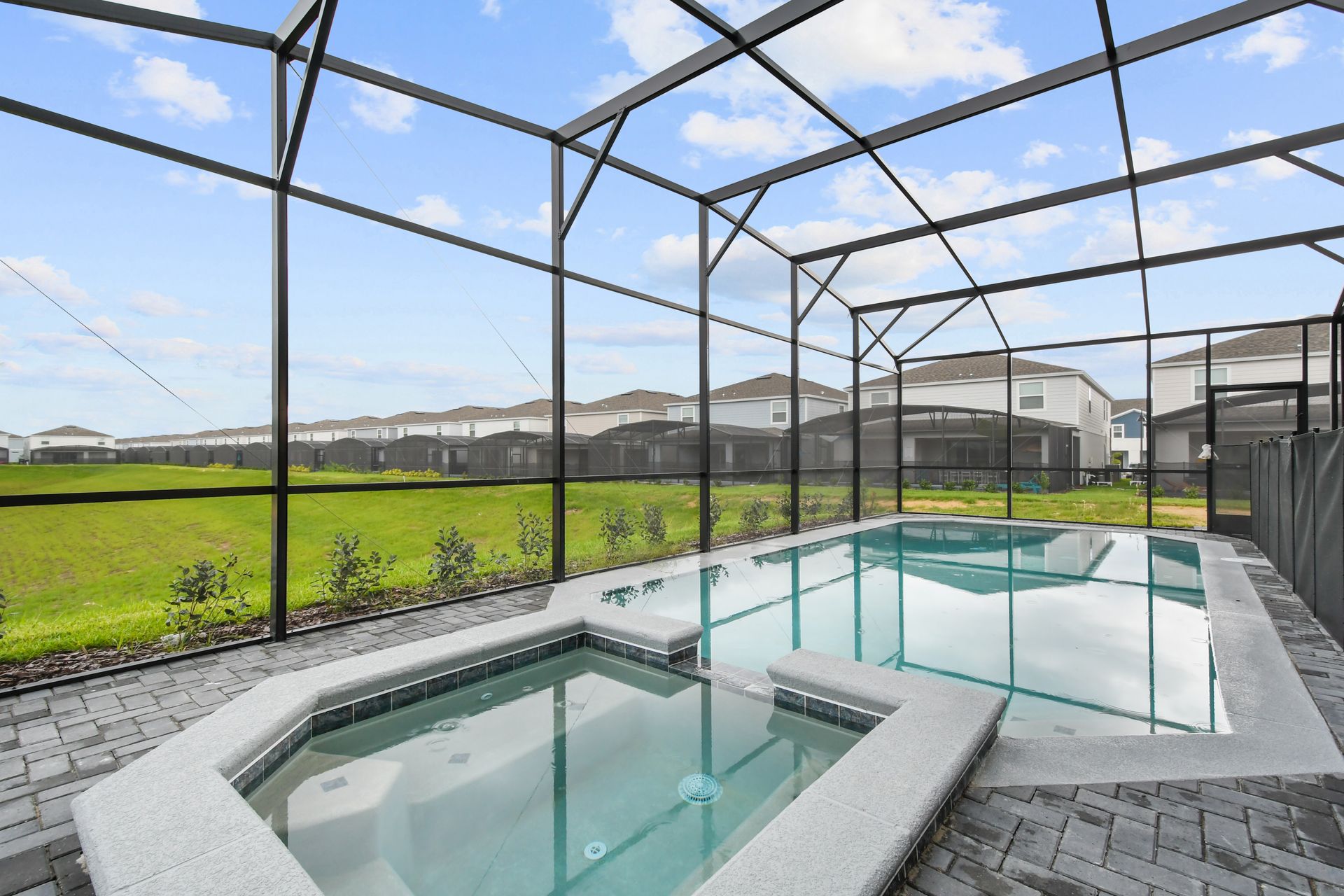 Private screened-in pool and spa with peaceful green views—pure relaxation.