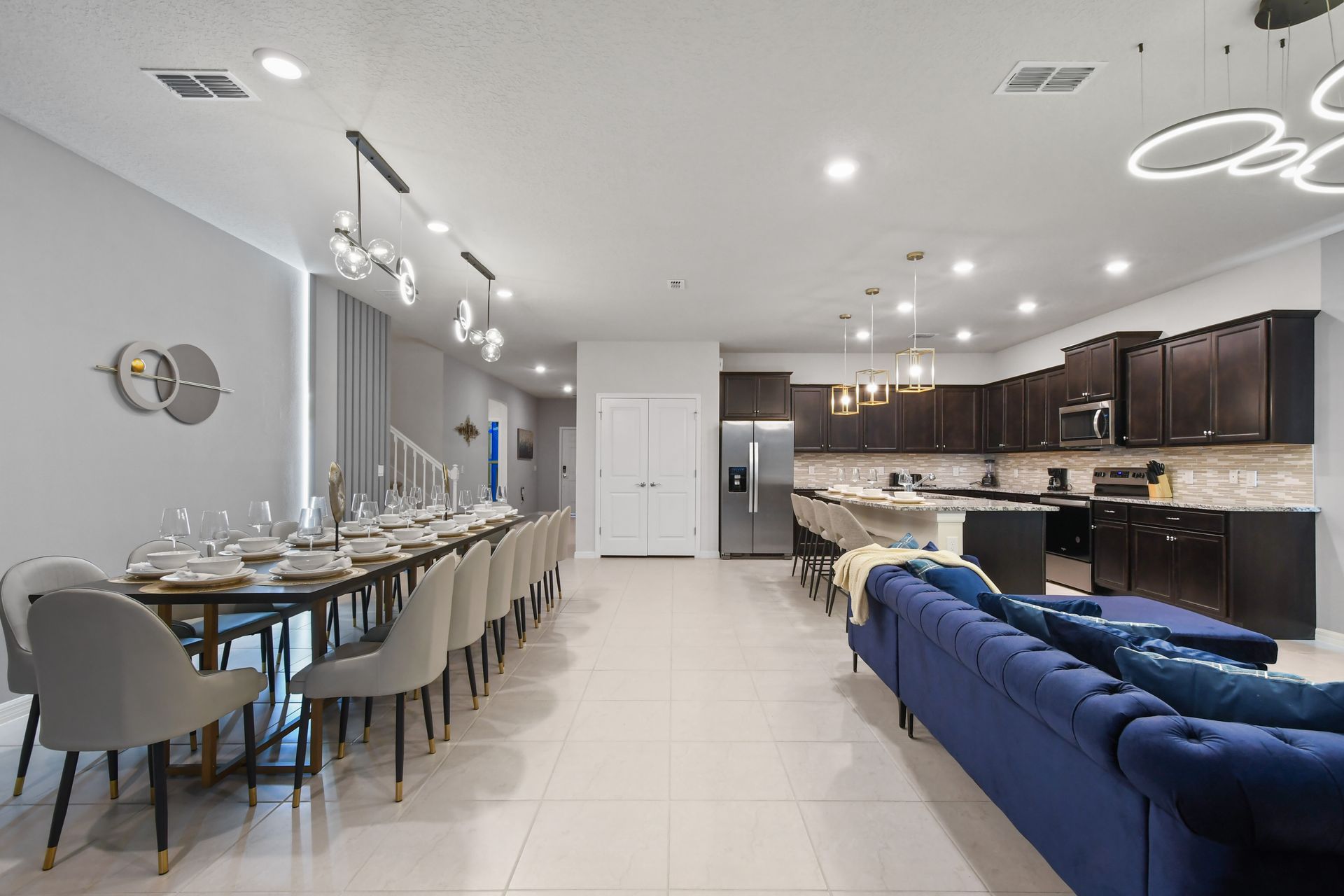 Modern open-concept layout with gourmet kitchen, luxe dining, and plush seating.