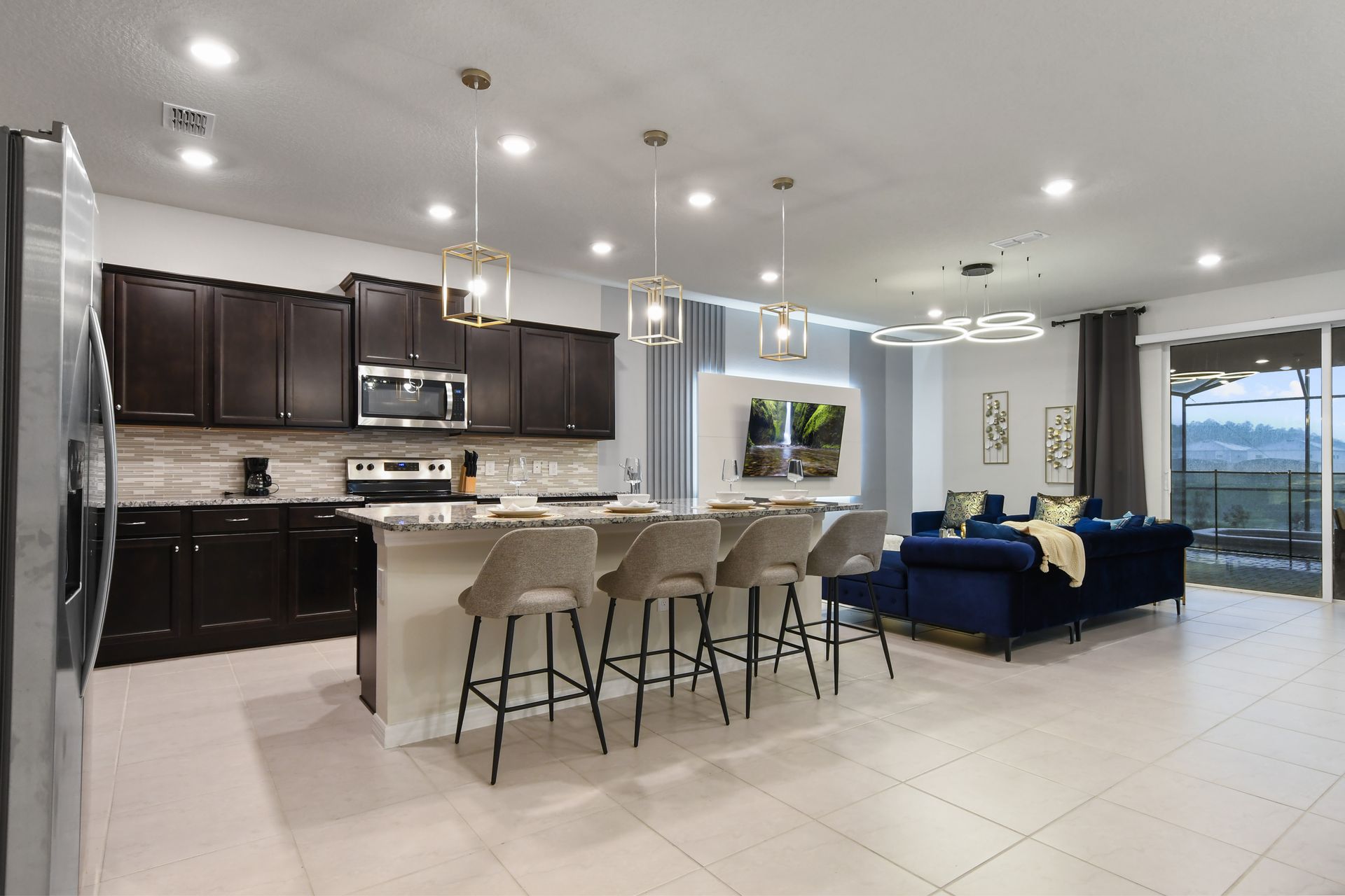 Stylish kitchen island and lounge area with sunset views and modern lighting.