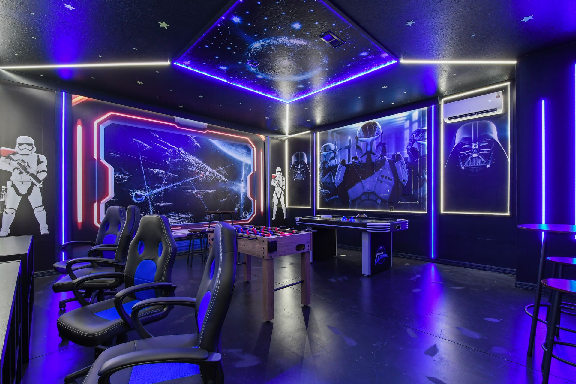 Galactic-themed game room with foosball, air hockey, and epic Star Wars décor.