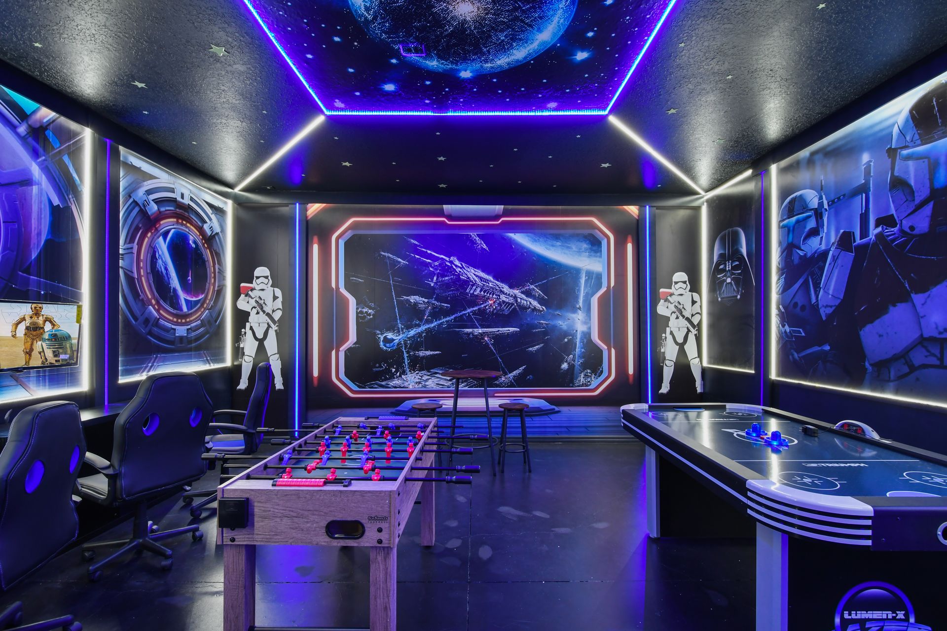 Futuristic Star Wars game room, neon lights, air hockey, and foosball included.