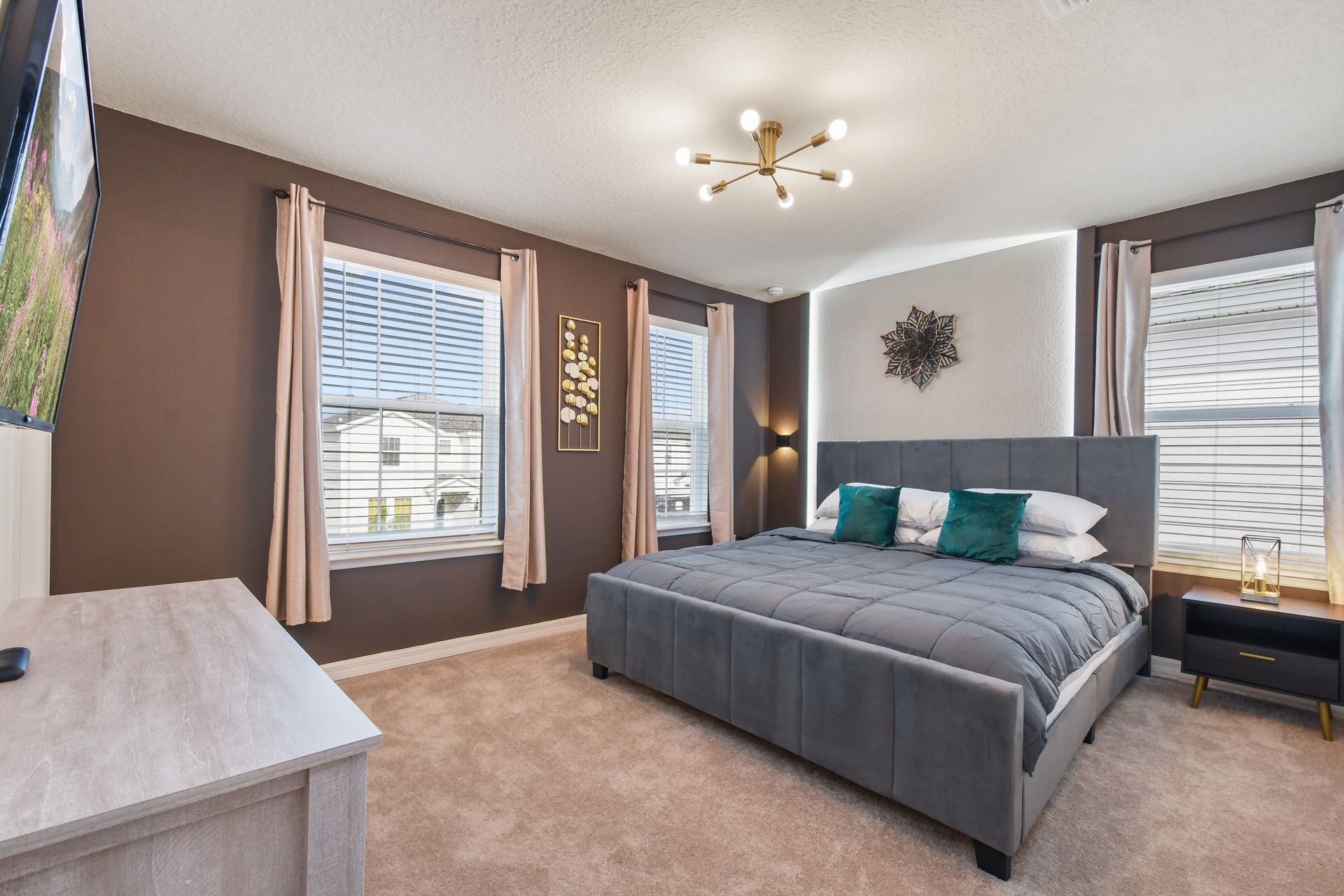Chic and cozy bedroom with a plush king bed, bold accents, and natural light.