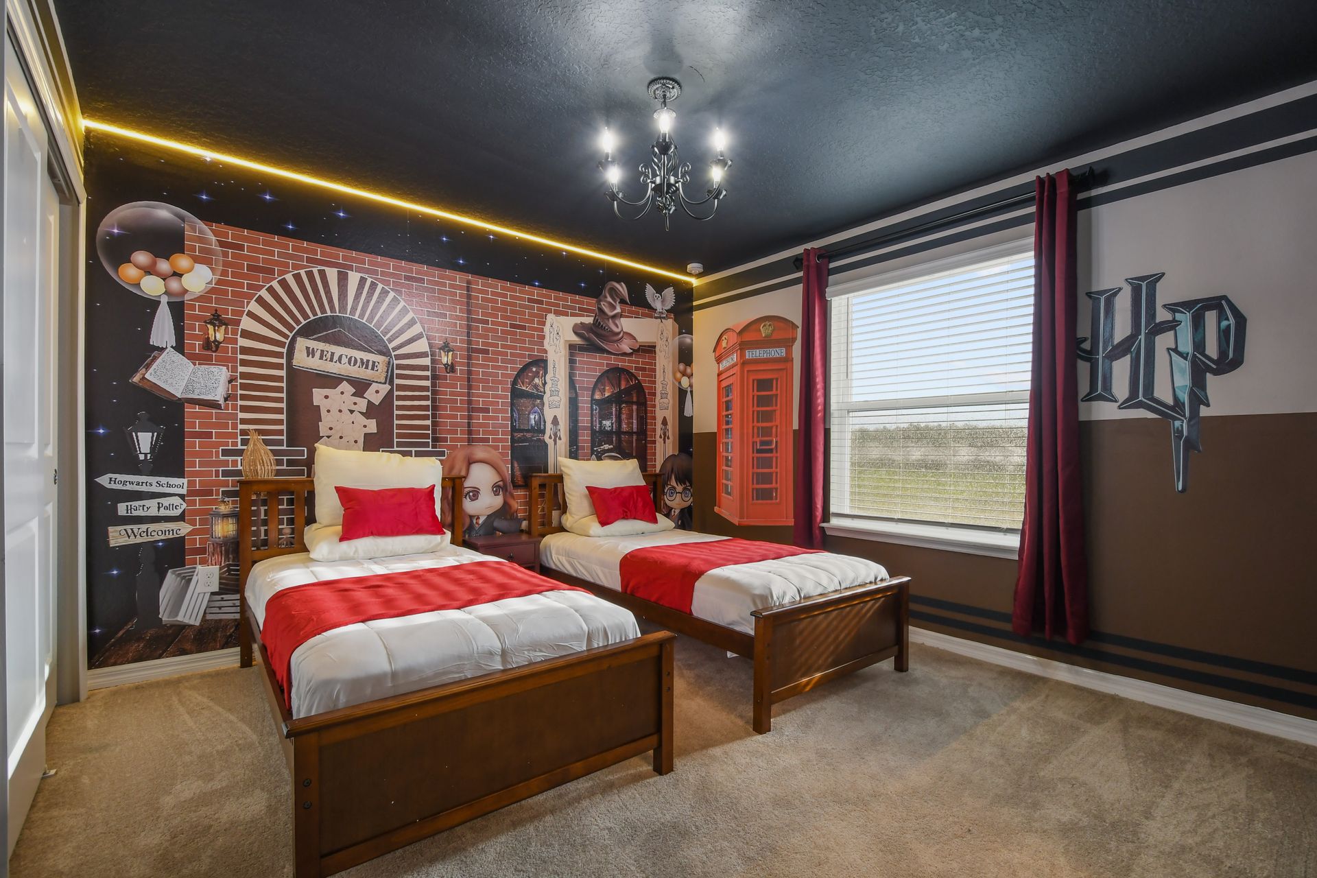 Whimsical Harry Potter room with twin beds and magical mural details.