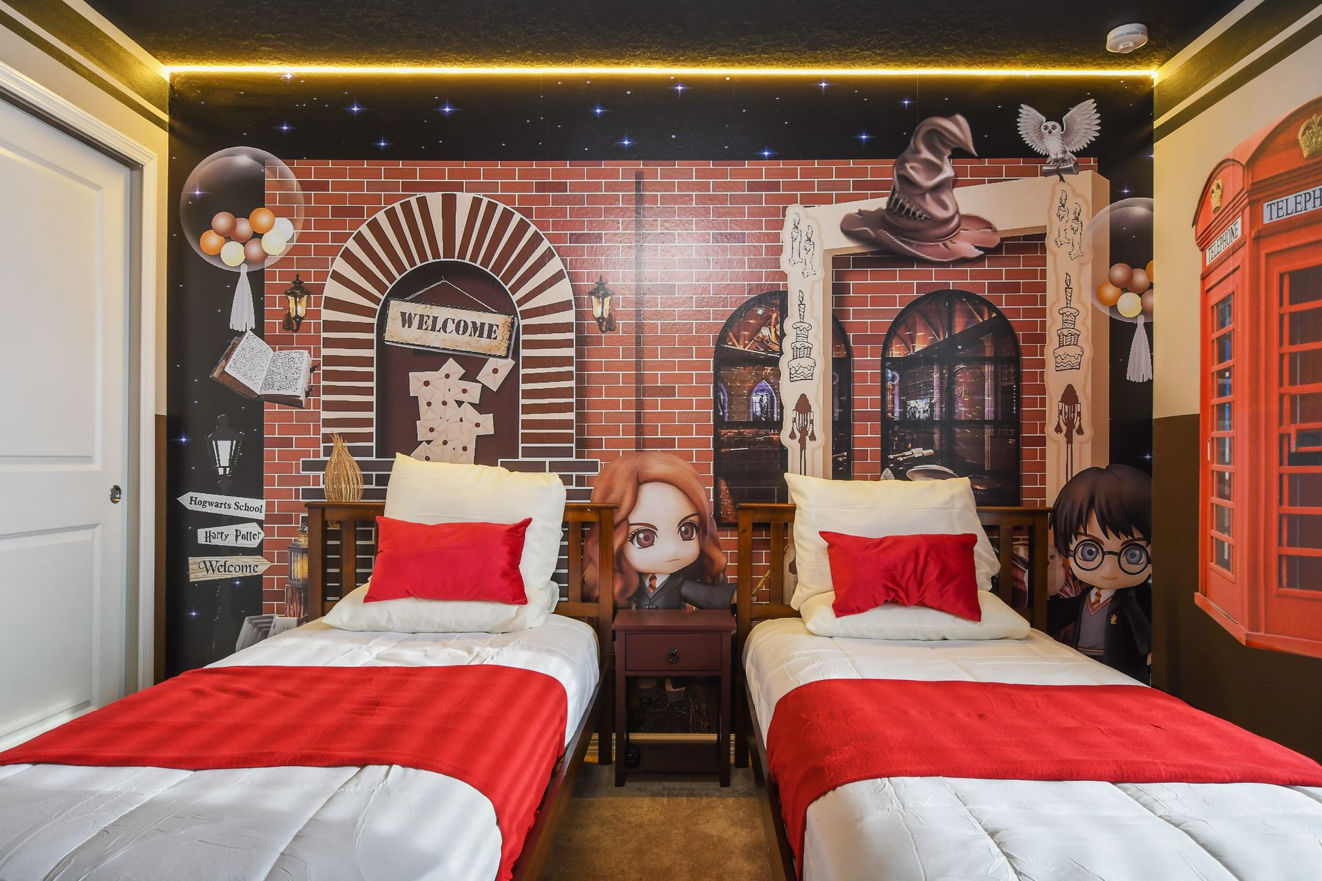 Spellbinding twin room with enchanting Hogwarts mural and magical charm.