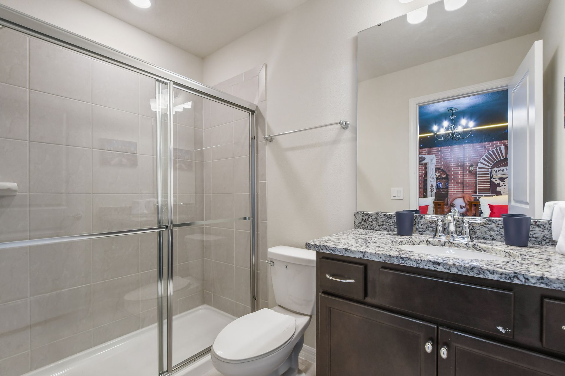 Elegant full bath with granite vanity and direct access to the Harry Potter room.