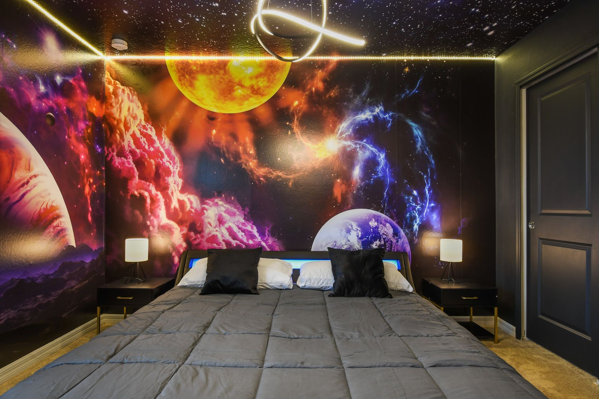Immerse yourself in a cosmic retreat with this galaxy-themed king suite.