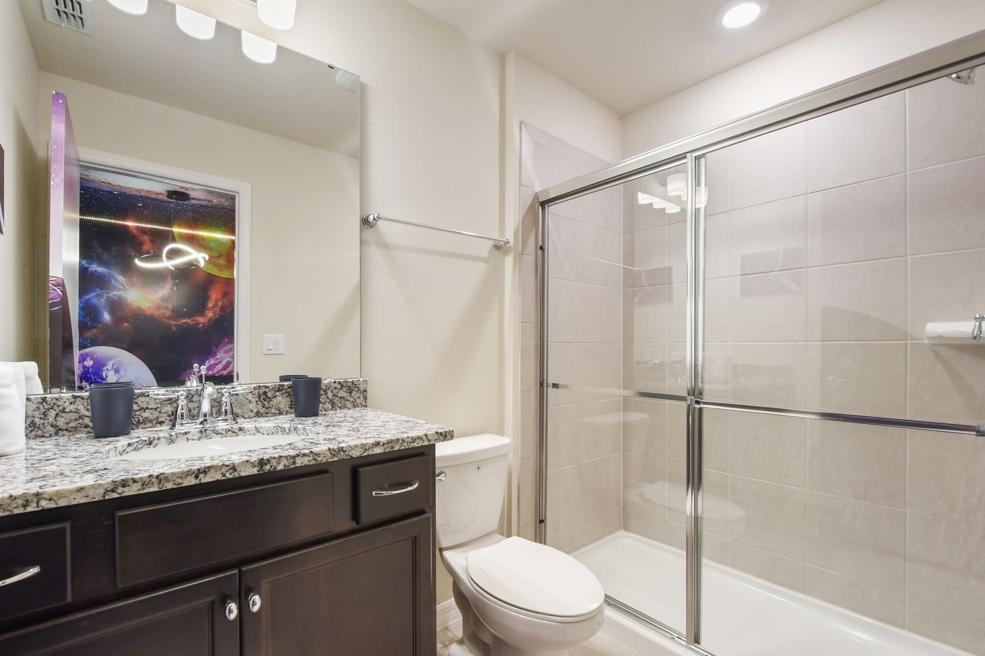 Modern bathroom with walk-in shower just steps from the galactic bedroom.