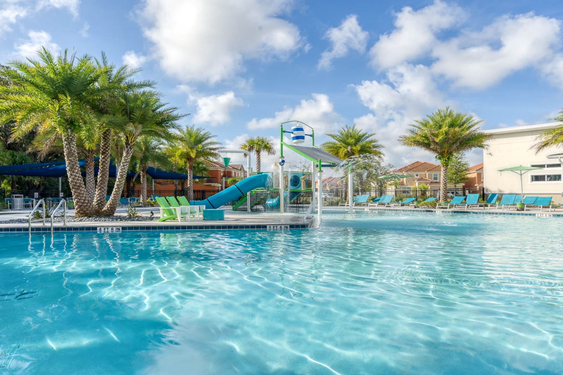 Resort-style escape with a sparkling pool, waterslides, and lush tropical views