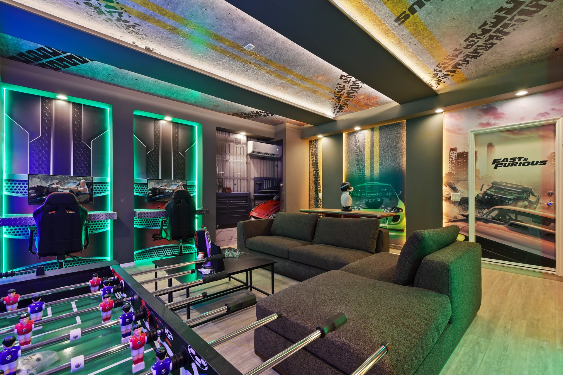 Fast & Furious-themed game room with racing simulators, foosball, and bold lighting.