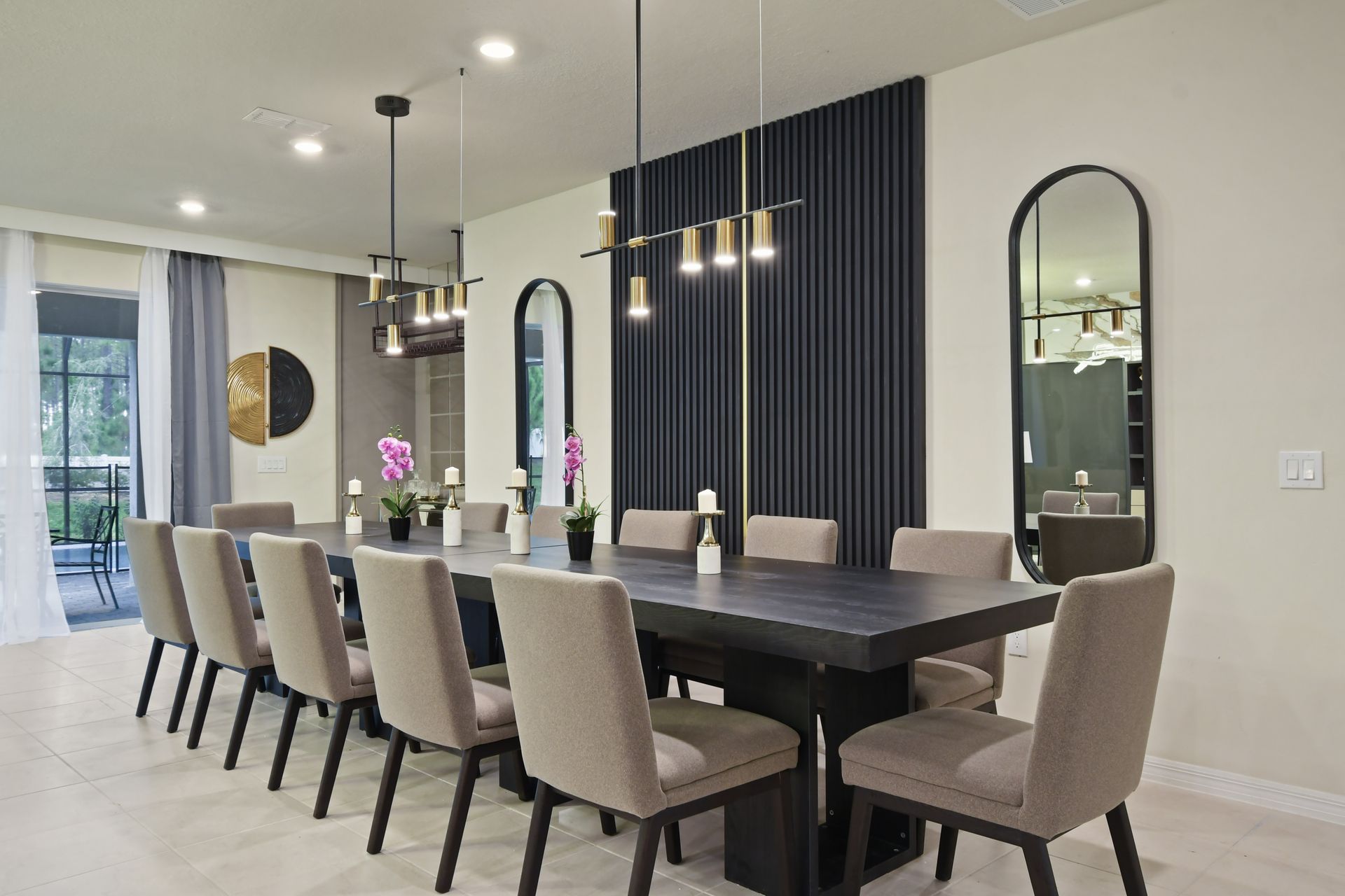 Elegant dining room with modern lighting, seating for twelve, and serene decor.