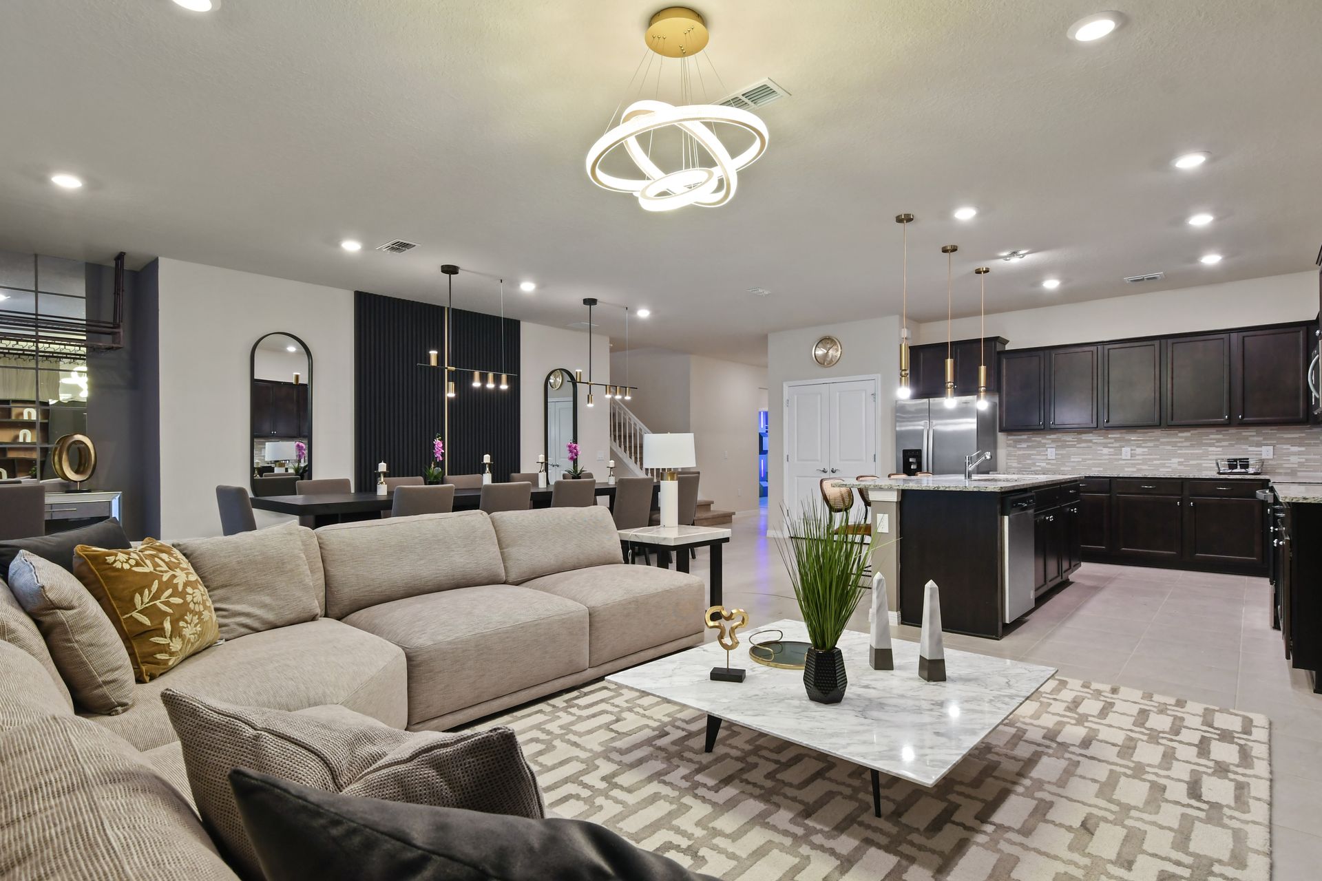 Modern living room with marble accents, cozy seating, and patio access for relaxation.