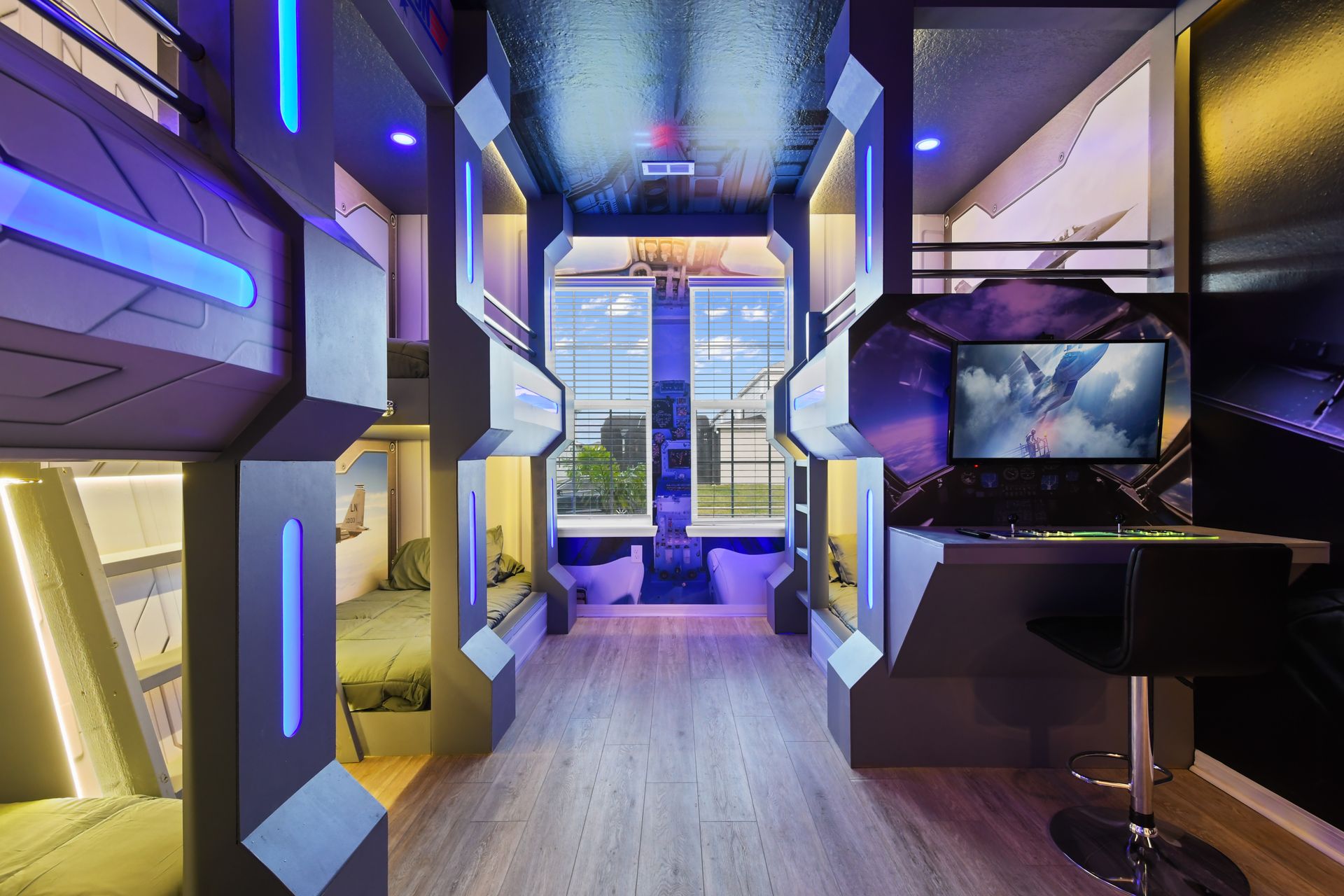 Futuristic bunk room with aviation theme, glowing lights, and gaming station.