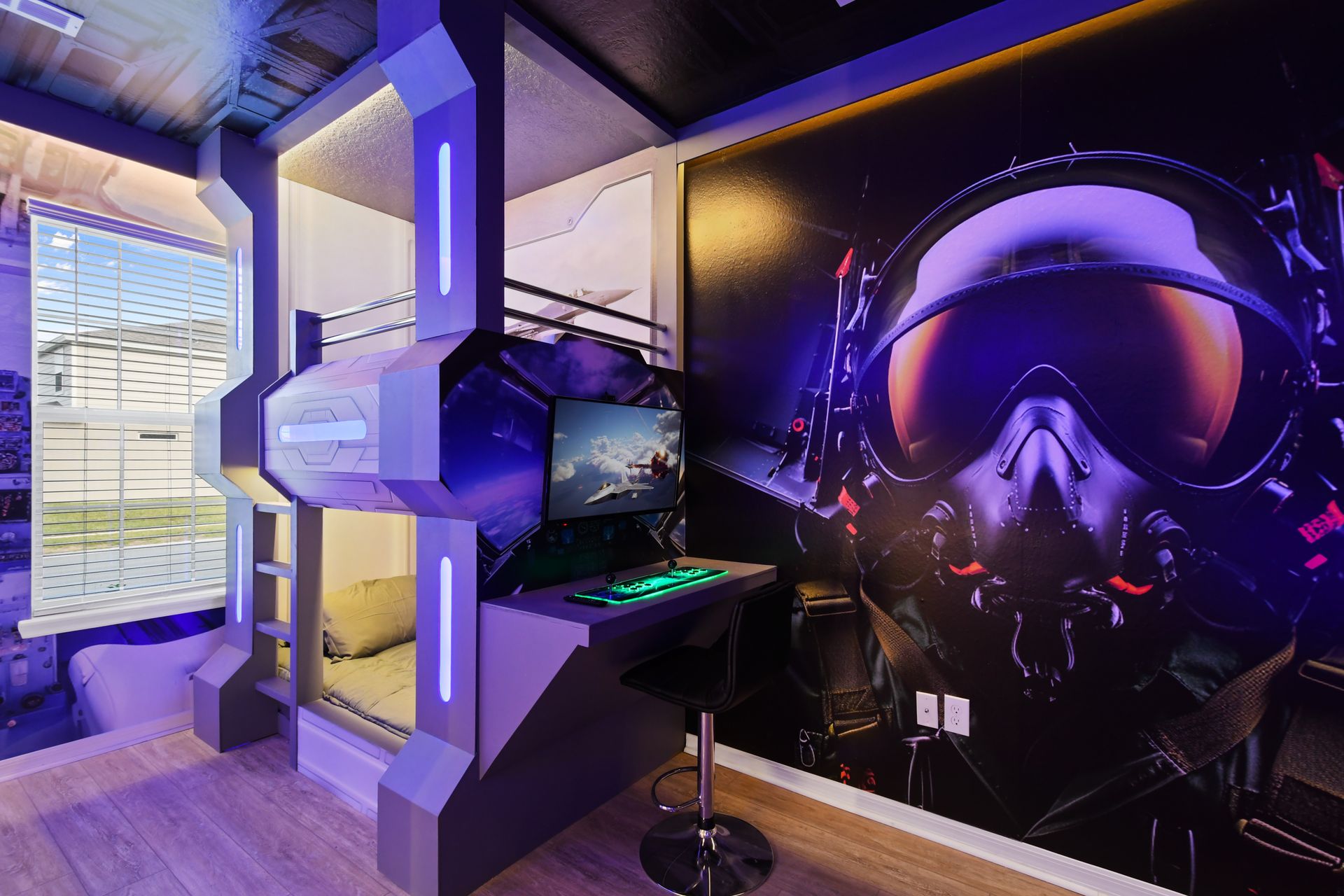 Futuristic pilot-themed bunk room with gaming setup, neon lights, and cool vibes
