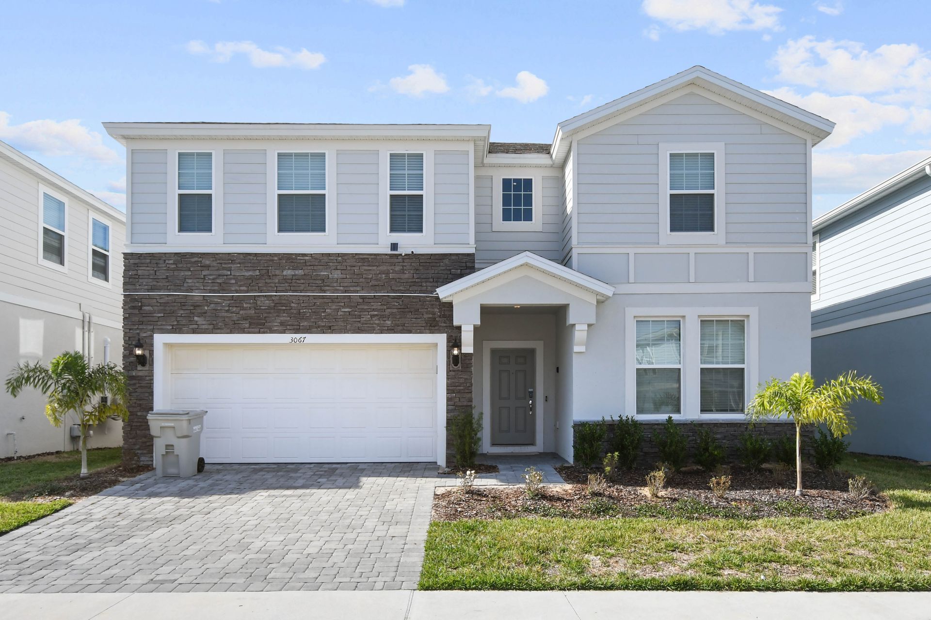 Modern family villa with garage, private pool, stylish rooms, and welcoming entryway
