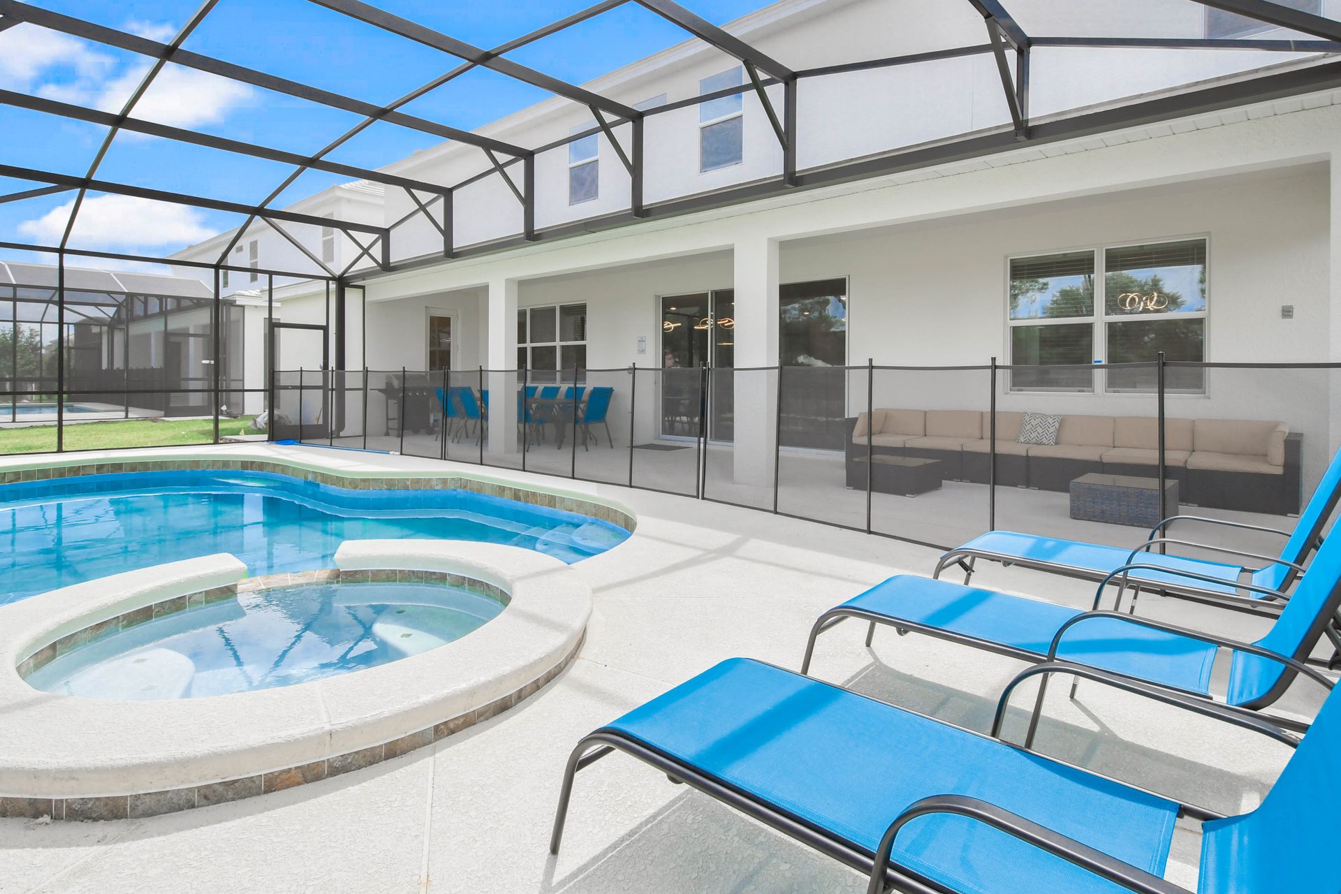 Relax and unwind in the private pool and hot tub area with ample lounge seating.