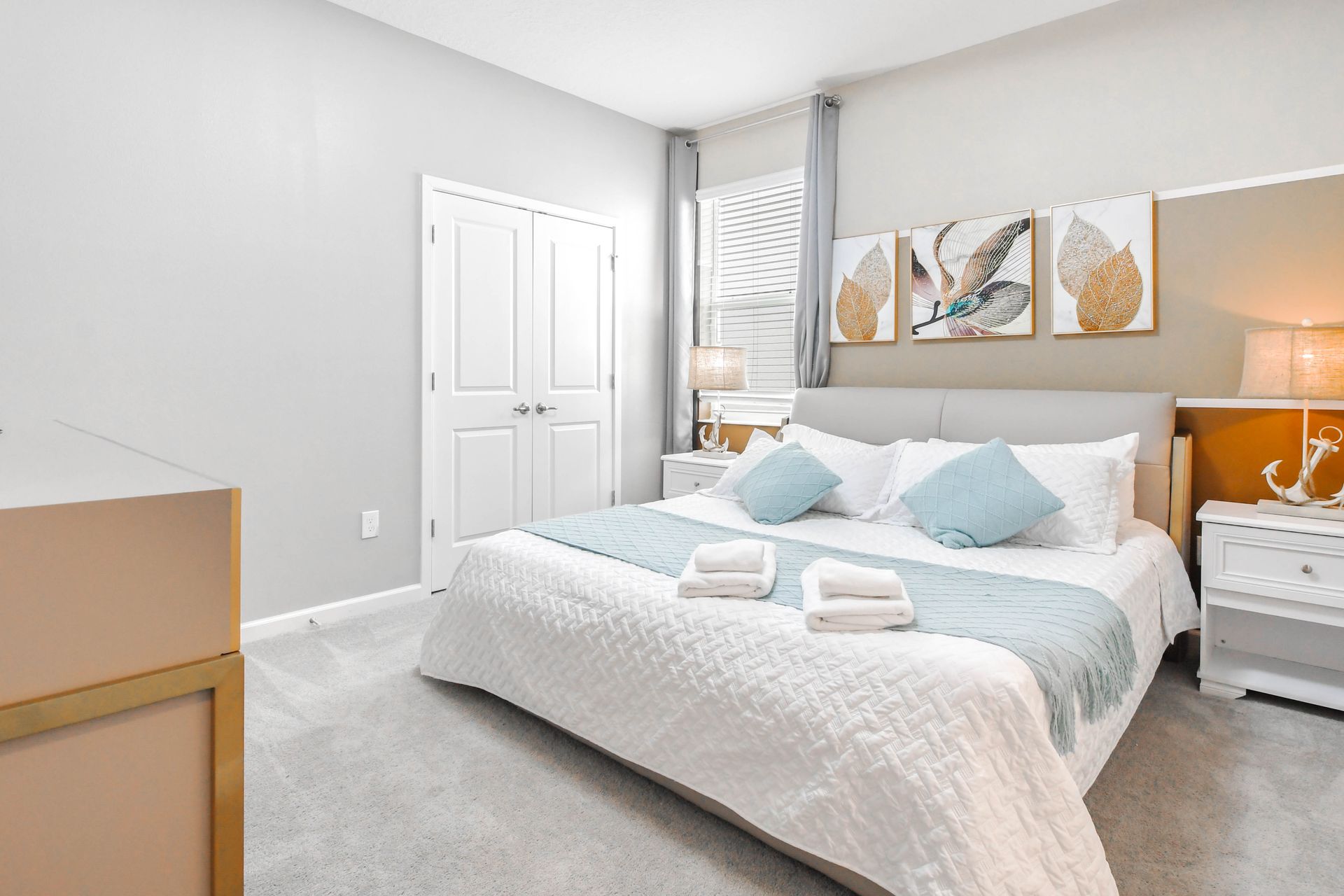 Serene king bedroom with soft blue accents, cozy lighting, and clean design.