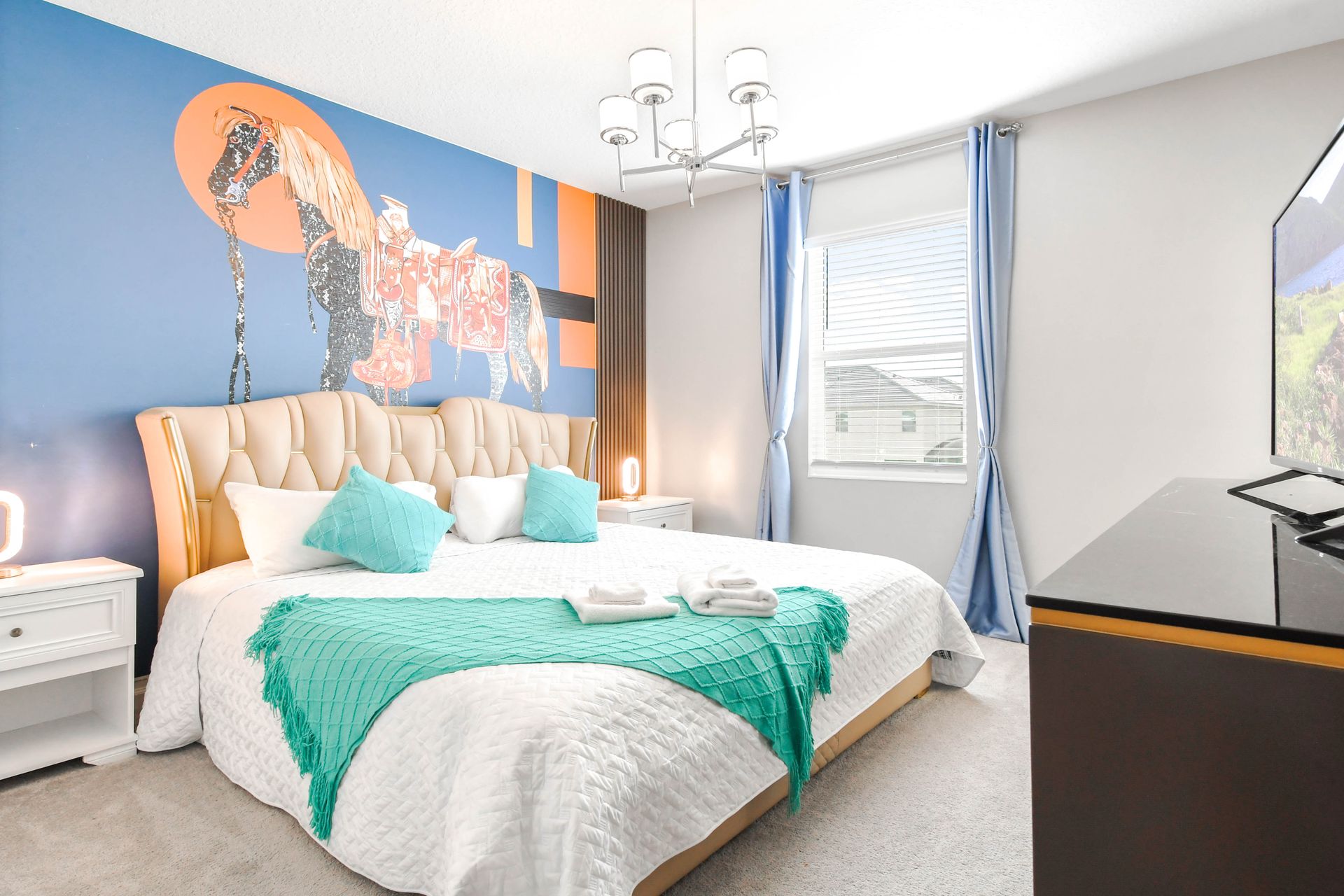 Bright, stylish bedroom with unique horse mural and elegant turquoise accents.