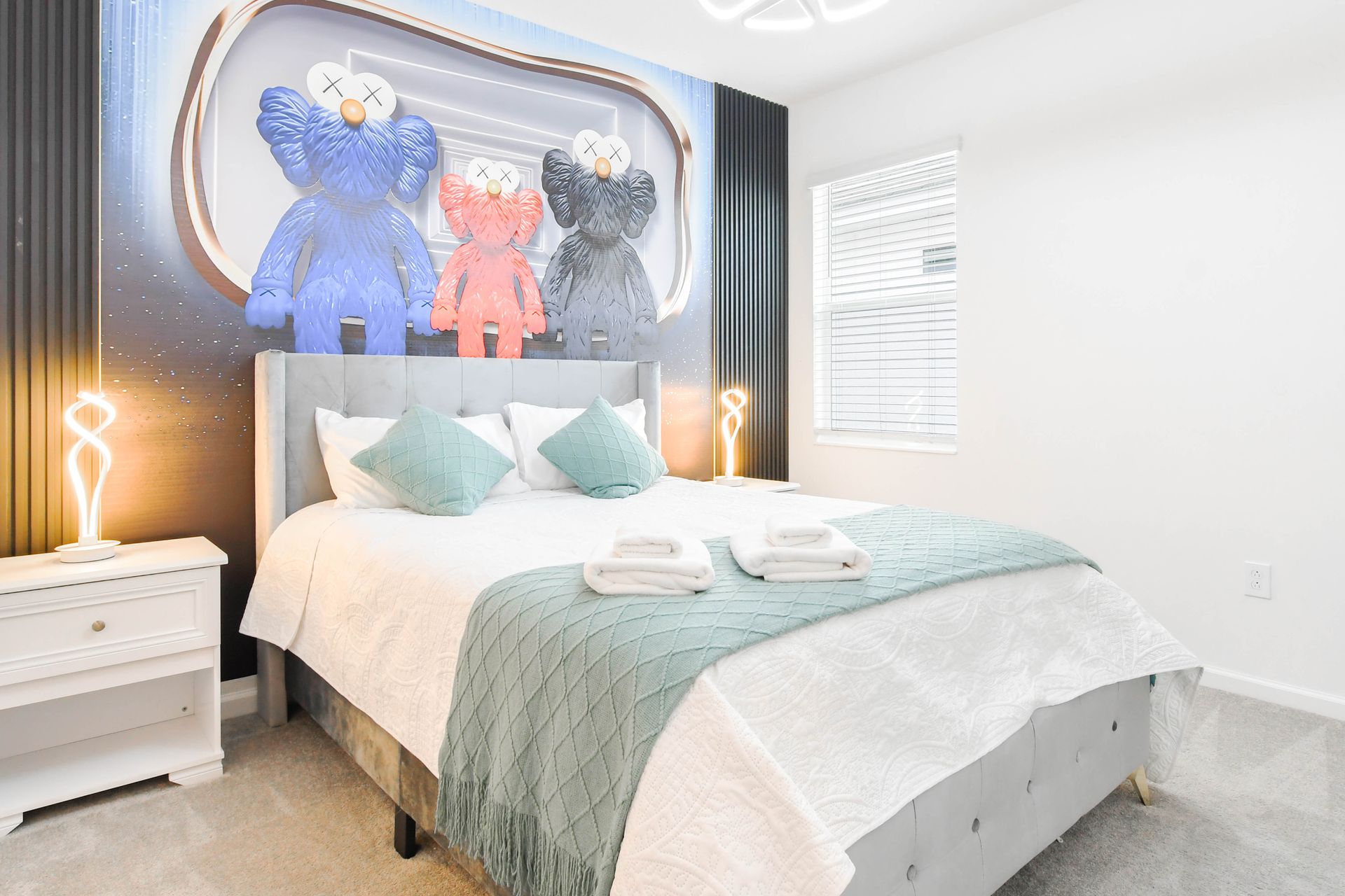 Modern bedroom with unique art, soft tones, and inviting comfort for a restful stay.