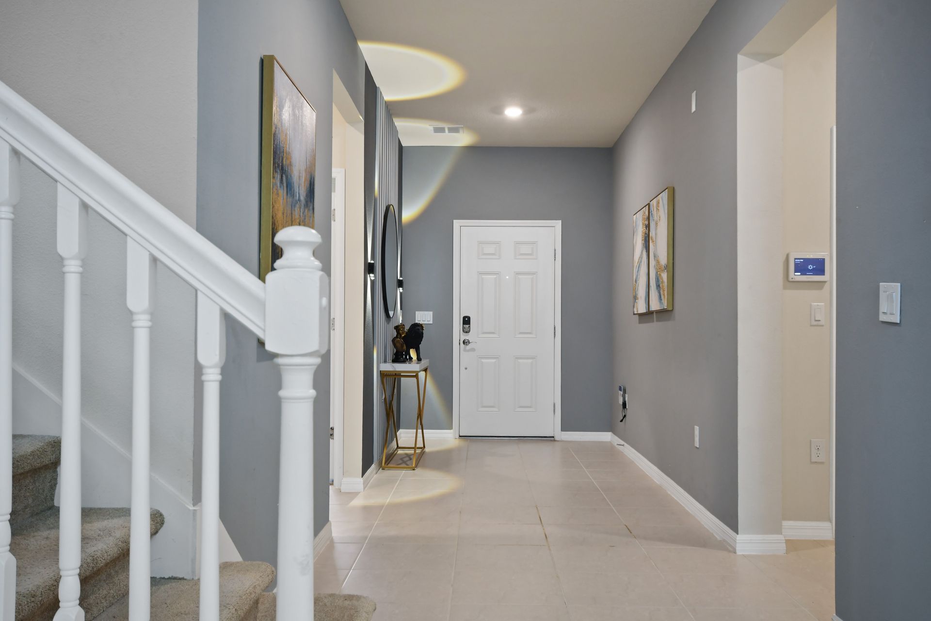 Stylish entryway with modern lighting and elegant decor sets a warm welcome.
