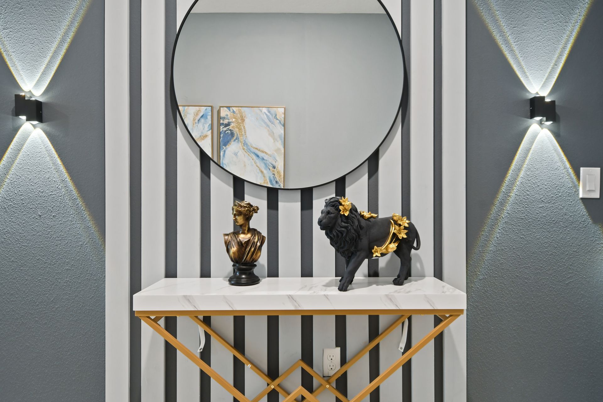 Elegant entry with luxe decor, bold accents, and striking modern lighting design.
