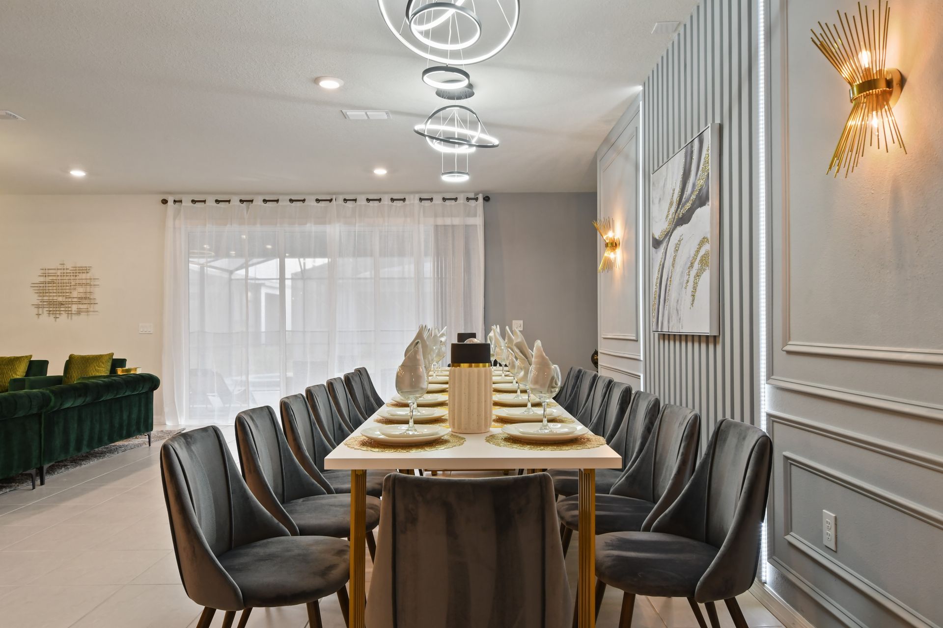 Elegant dining room with seating for 12, modern lighting, and gold accents.
