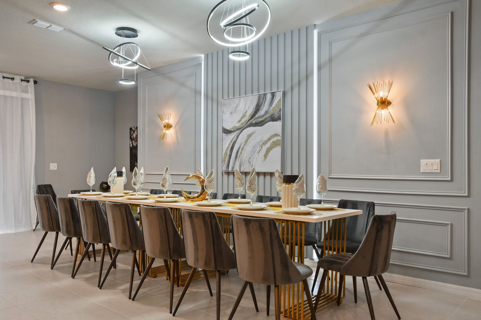 Large dining table surrounded by plush chairs, perfect for intimate gatherings or lavish dinners.