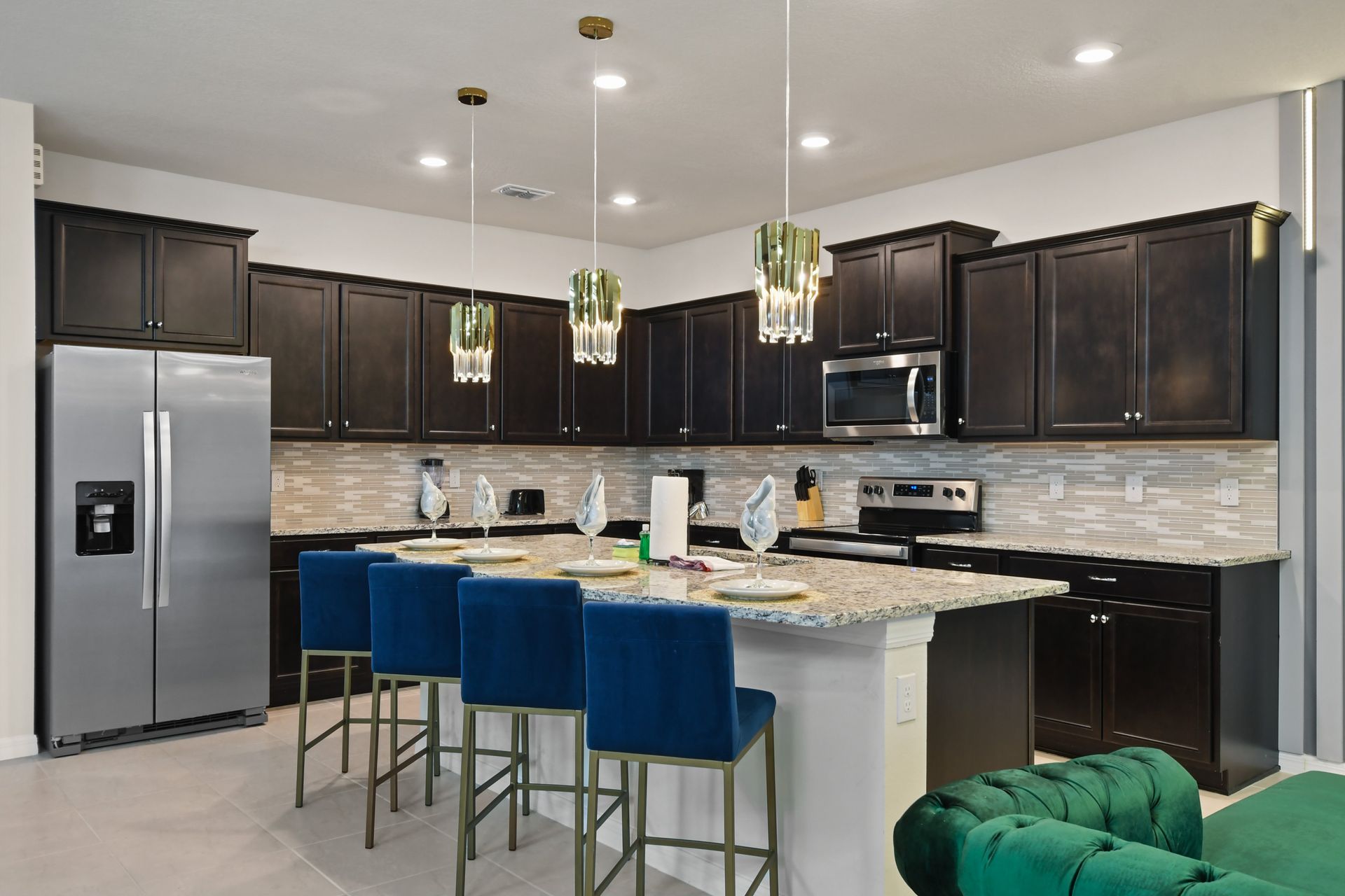 Modern chef’s kitchen with granite countertops, sleek cabinets, and stylish seating.
