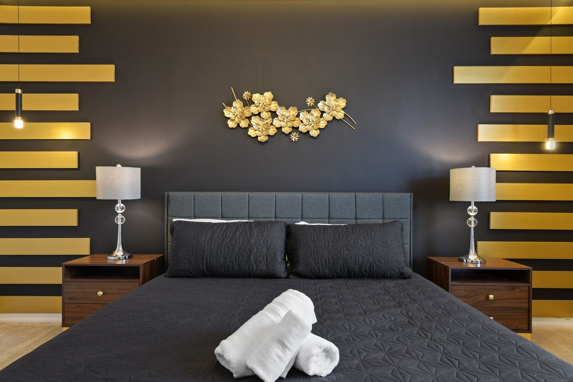 Chic king bedroom with bold gold accents, modern décor, and plush comfort.
