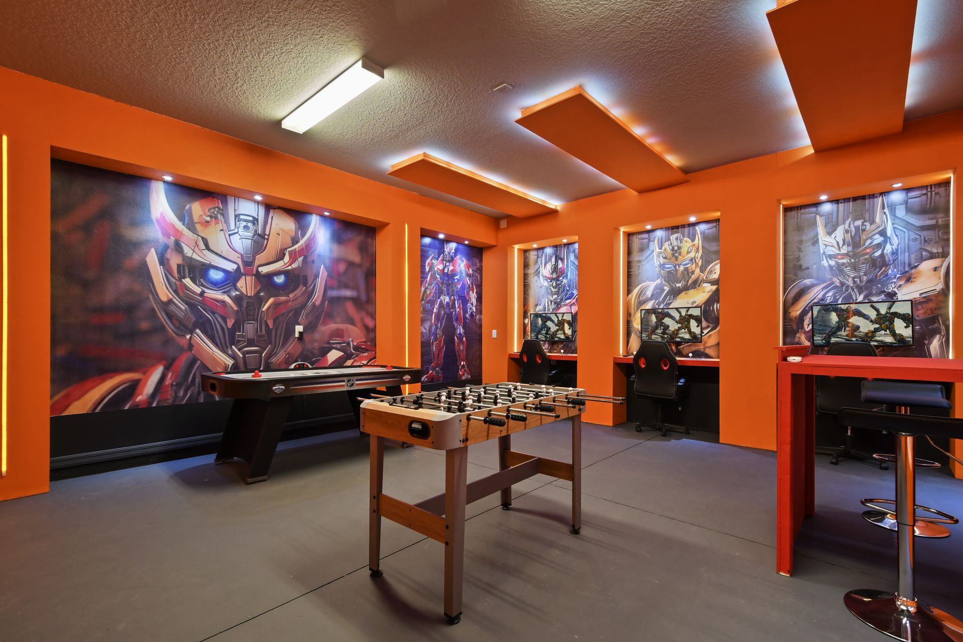 Step into an action-packed Transformers-themed game room, perfect for fans of the iconic series. Equipped with a foosball table, and an air hockey table, and computers.