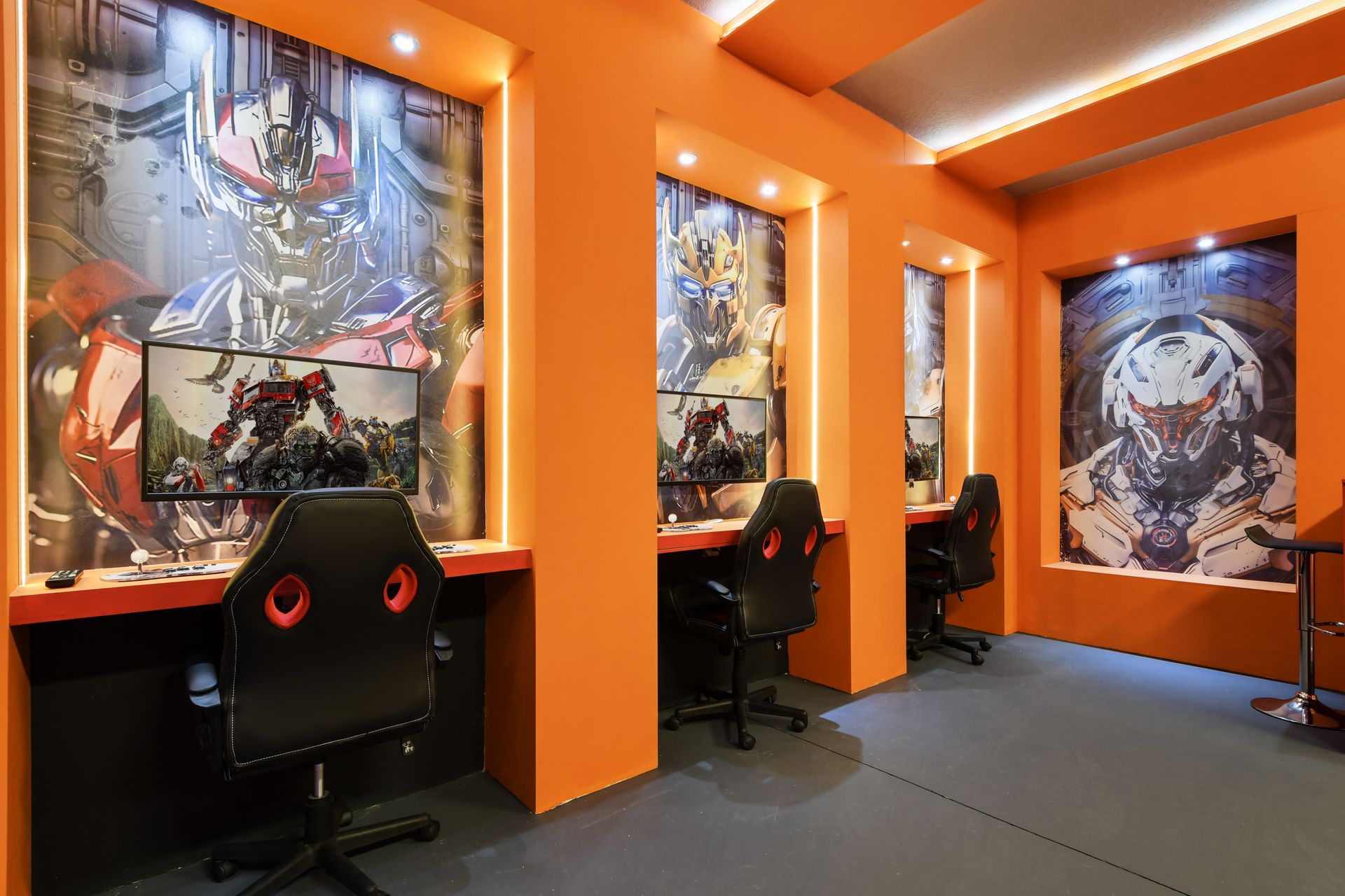 Immersive sci-fi gaming station with themed PCs, LED lighting, and pro chairs.
