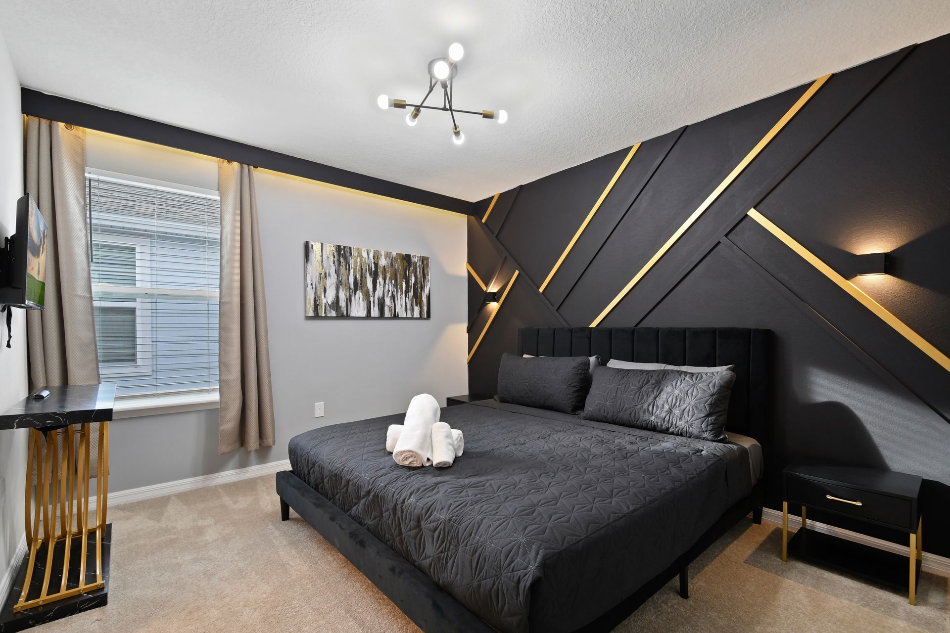 Bold and modern king bedroom with geometric gold accents and sleek black design.
